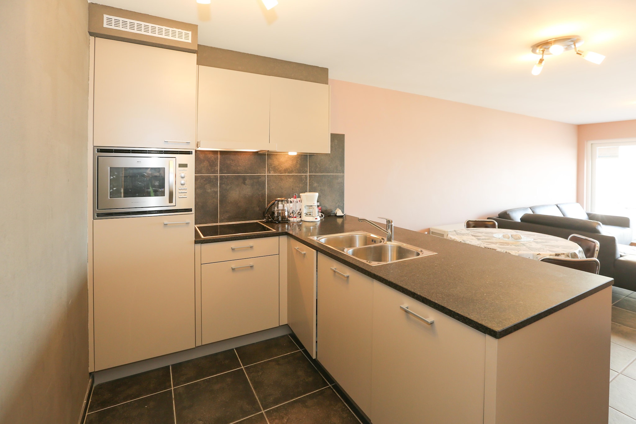 On the 1st floor: (open kitchen(hob, electric kettle, coffee machine, combination microwave, fridge(+ freezer)), Living/diningroom(TV(digital), dining table, seating area, DVD player), bedroom(double bed(twin duvet, 160 x 200 cm)), bedroom(single bed(duvet, 90 x 200 cm), single bed(duvet, 90 x 200 cm)), bathroom(shower, washbasin), toilet(toilet))\n\nwashing machine, heating(electric), lift