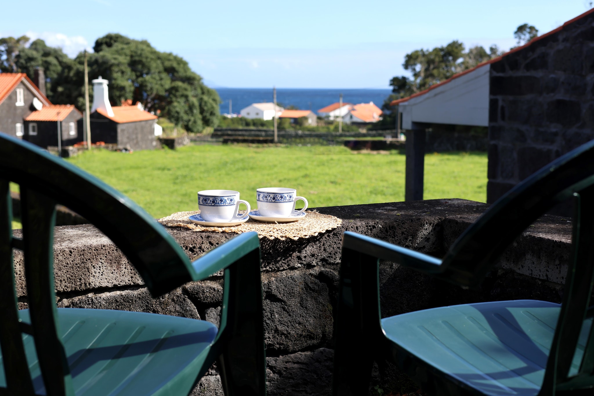 In the small coastal town of Santo Amaro in the northeast of Pico, this stone house is located in a rural, quiet environment. Inside, the spacious house impresses with its cozy ambience, which is underlined by wooden floors, furniture and beams.
After eventful excursions, end the day in the cozy barbecue area and enjoy the panoramic view.
Pico offers its guests a wide range of leisure activities: bathing enthusiasts will find natural swimming pools just 300 m away. Go on hikes through the wonderfully green surroundings and experience the impressive volcanic landscape of the second largest island in the Azores. From Madalena you can go on whale and dolphin watching excursions or a trip to Faial.
Note: Sloping ceilings on the upper floor. The outdoor area/garden is also partly used by the guests of the neighboring house. Mobile heaters can be provided upon request (for a fee).