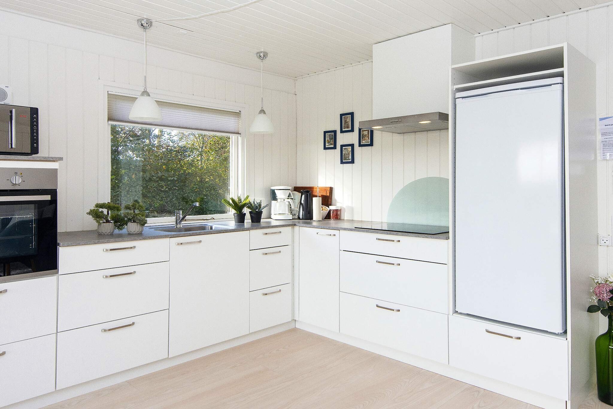 Kitchen(cooker(2 ring stoves), coffee machine, oven, microwave, fridge, freezer(60-99L)), Living/bed room(TV(danish TV channels (DR1 and TV2)), chromecast), bedroom(double bed, high chair), bedroom(double bed), bedroom(2x bunk bed), bathroom(washbasin, shower, toilet, washing machine), heating(electric), terrace, garden furniture, sun loungers, play equipment, air to air heatpump