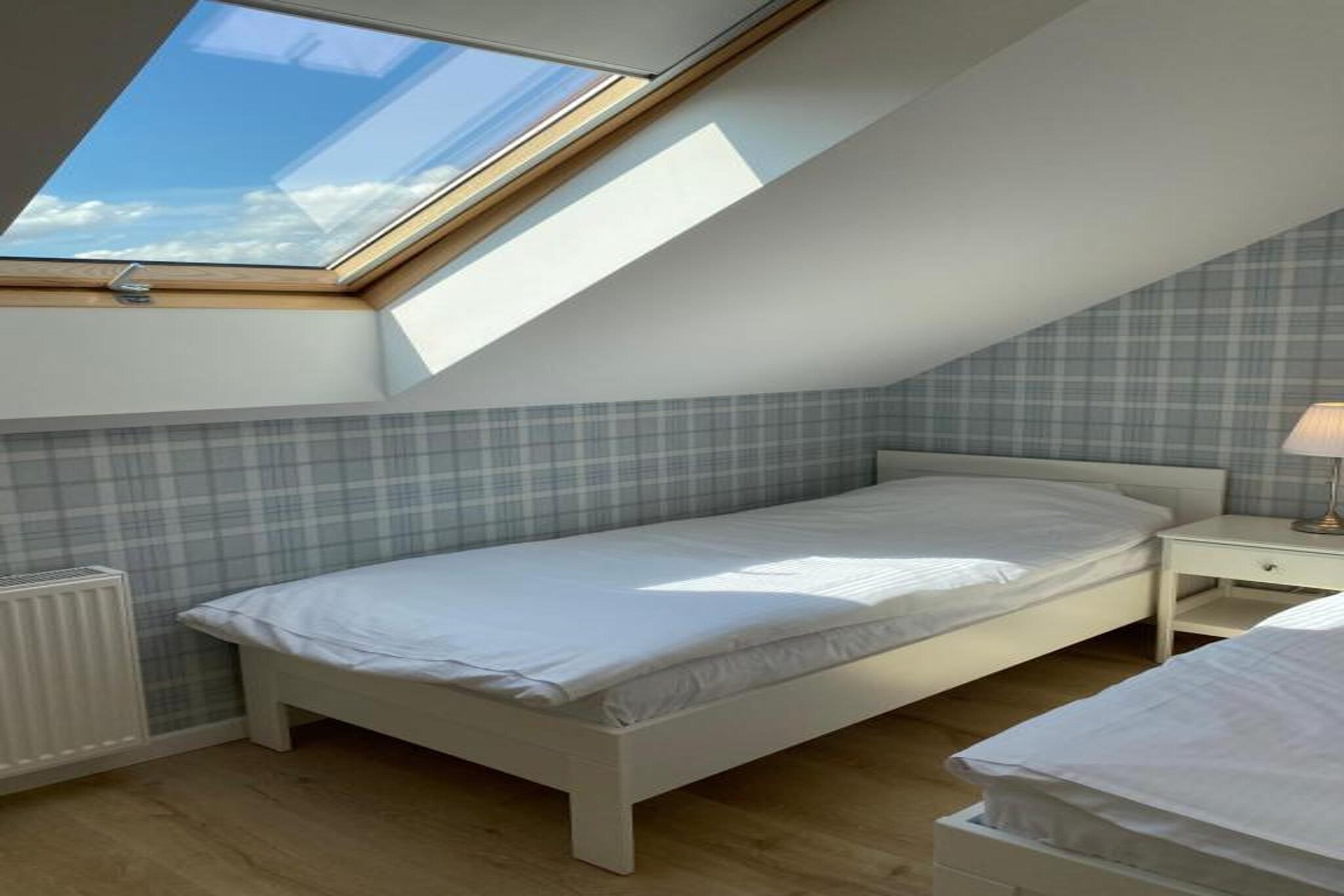 Ground floor: (open kitchen(hob, electric kettle, dishwasher, fridge-freezer), Living/diningroom(double sofa bed, TV(flatscreen), dining table), bathroom(shower, washbasin, toilet, washing machine, hairdryer))\n\nOn the 1st floor: (bedroom(double bed), bedroom(single bed, single bed))\n\nInternet access, Parking, Play area, heating(central), terrace, garden(shared with other guests), garden furniture, BBQ(charcoal), sand pit(shared with other guests), slide(shared with other guests), high chair, ironing board, iron, Garden shed, Swing set