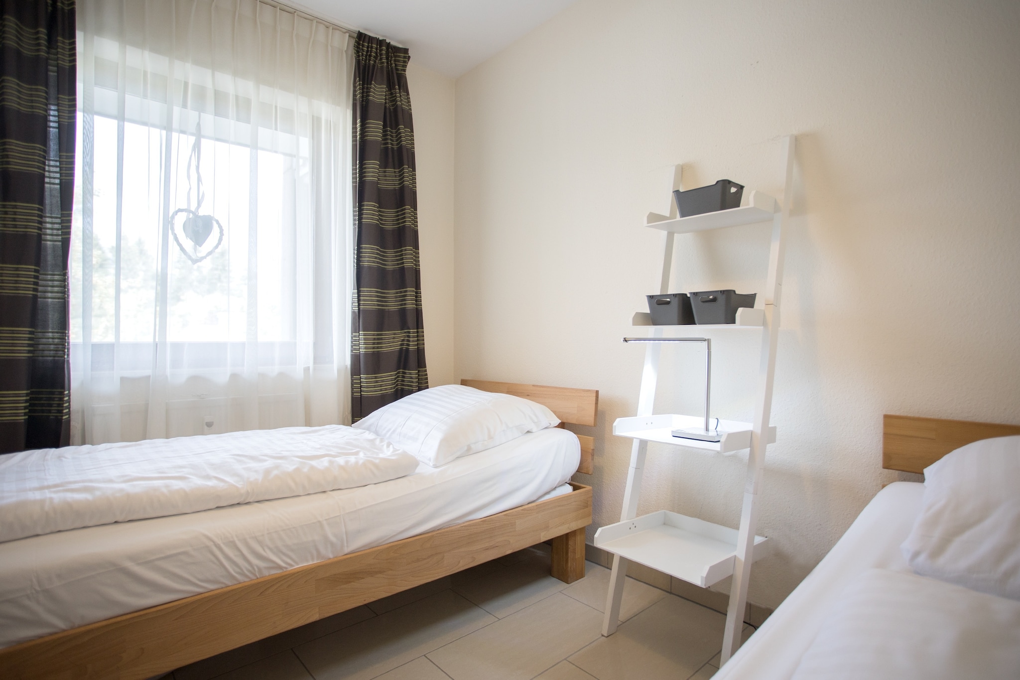 On the 2nd floor: (open kitchen(dining table, hob, electric kettle, toaster, coffee machine(filter), microwave, dishwasher, fridge(+ freezer)), Living/diningroom(double sofa bed, TV(flatscreen), seating area), bedroom(single bed(80 x 200 cm), single bed(80 x 200 cm)), bathroom(shower, washbasin, toilet), Landing)\n\nstorage, cot, balcony, parking, lift, high chair