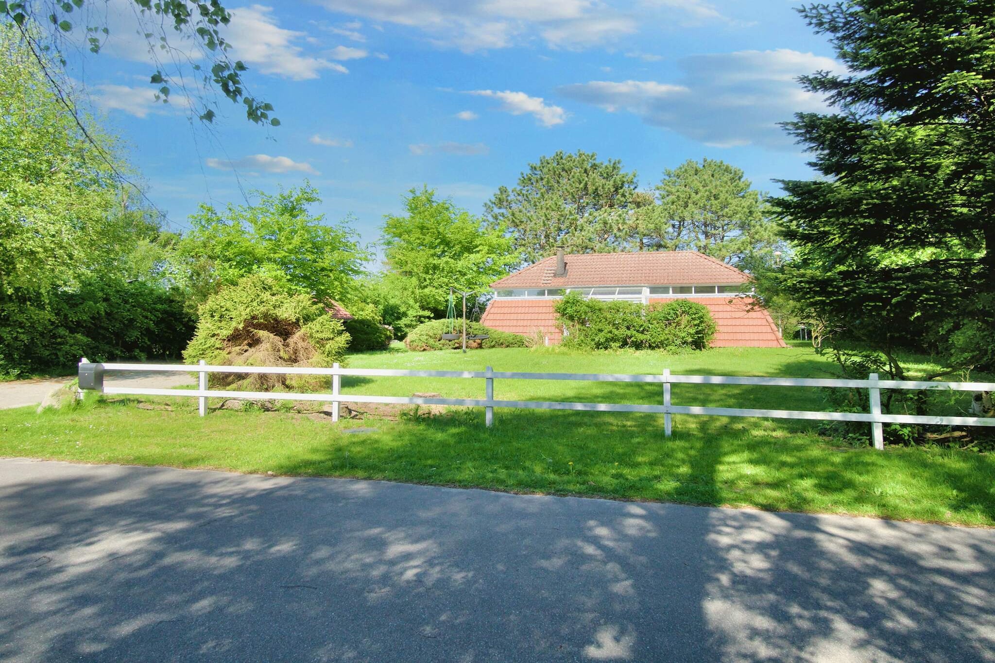 Relax and unwind in this inviting holiday home, perfectly situated in a quiet vacation area. Inside, cozy evenings await in the living room, where you can sit by the wood-burning stove while listening to your favorite music on the stereo or streaming entertainment via Chromecast on the large TV. The home offers two spacious bedrooms for a restful stay: one with a double bed and a single bed, and the other with a comfortable double bed. The fully equipped kitchen makes mealtimes easy and enjoyable, featuring an electric stove, oven, fridge with freezer, coffee machine, and dishwasher. Freshen up in the modern bathroom, complete with shower, toilet, and sink. Step outside to enjoy the large, well-kept garden of approximately 1,000 m². The terrace is perfect for relaxing on garden furniture or sun loungers, while the charcoal grill invites you to enjoy delicious barbecues. Children will delight in the outdoor play equipment, making this property ideal for families. For your comfort, the house is equipped with electric heating and an air-to-air heat pump, ensuring a cozy environment year-round. As a non-smoking property, it provides a calm and peaceful retreat. Its location in a quiet holiday home area makes it the perfect choice for a relaxing family getaway, with plenty of space to enjoy nature, play, and unwind. No rental to youth groups!A refundable deposit might be charged closer to your check-in date. The security deposit ensures a smooth stay and covers any additional services or consumption charges.This deposit covers utilities consumed during your stay and any additional services that may be taken.The final amount will be adjusted based on actual meter readings, actual usage of extra services, and any remaining balance will be refunded within 21 days after checkout.This deposit simply acts as a prepayment for charges that  you would anyways pay for, ensuring a seamless stay and check-out experience.