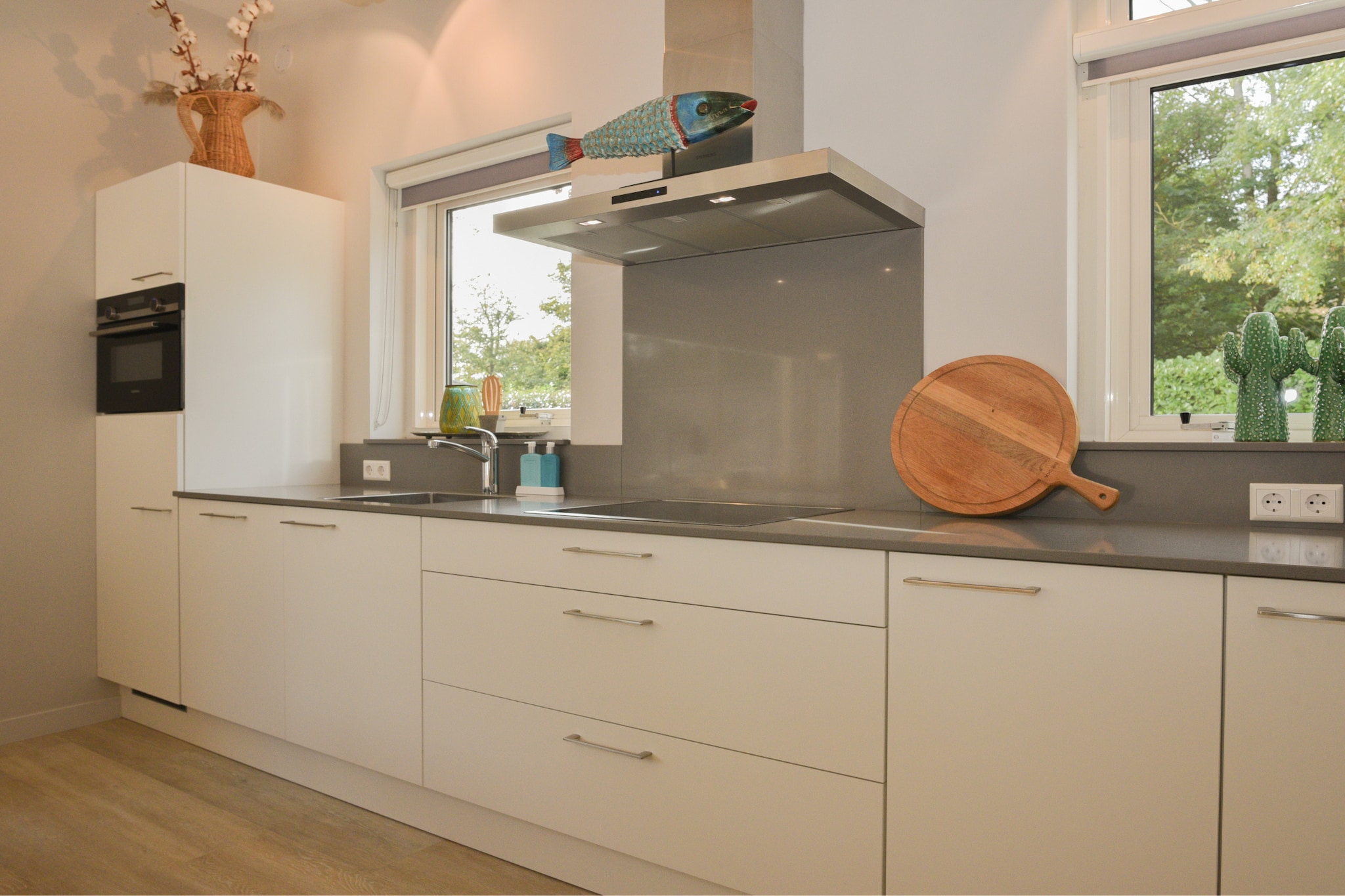 Ground floor: (Living room(seating area), open kitchen(toaster, coffee machine, dishwasher), bedroom(double bed), bedroom(single bed, single bed), bathroom(shower, washbasin), toilet(toilet))\n\nterrace, garden, BBQ, parking