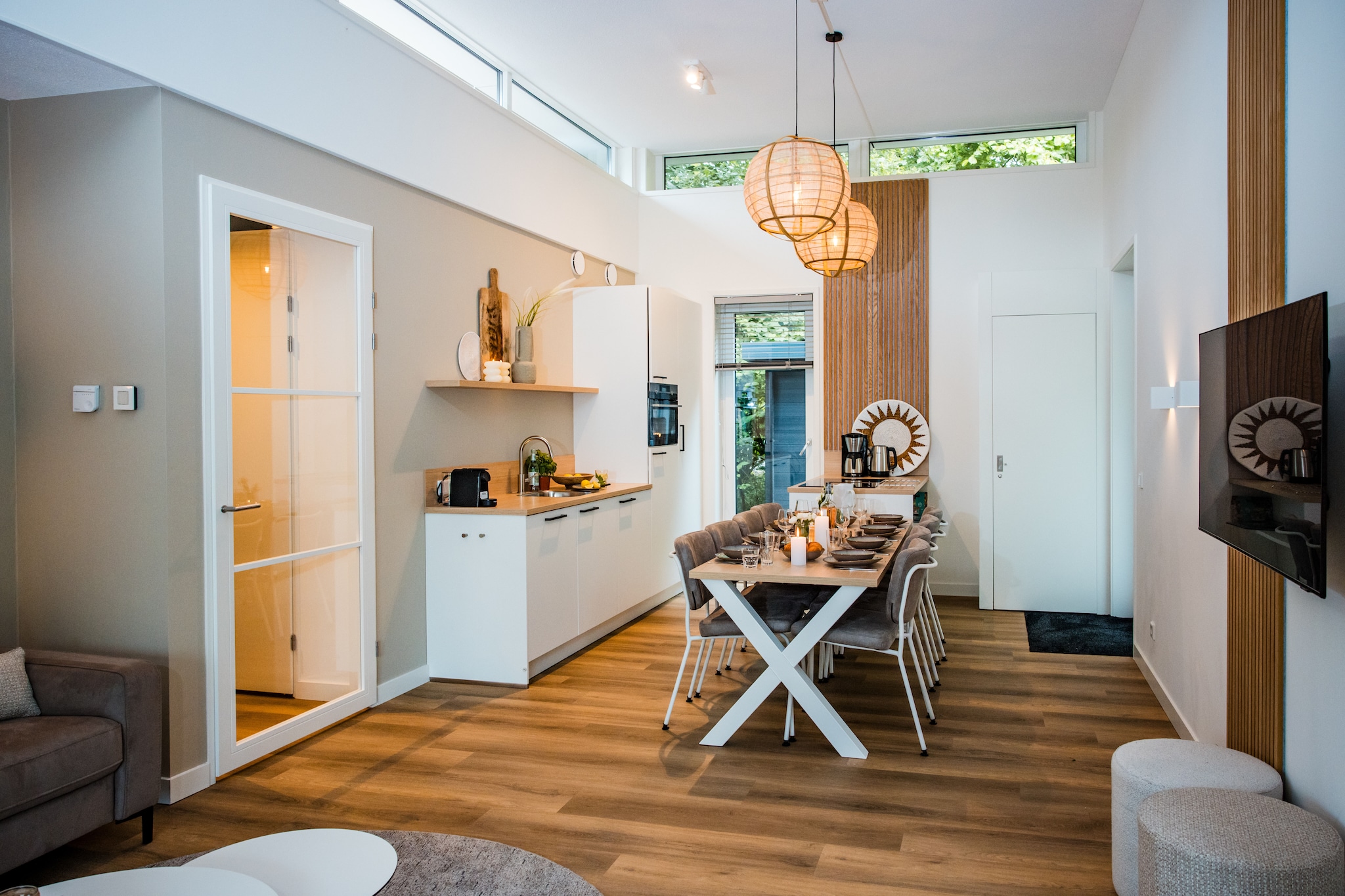 Ground floor: (Living room(TV, dining table(8 persons), seating area), Kitchen(electric kettle, coffee machine, oven, microwave, dishwasher, fridge, freezer), bedroom(double bed), bedroom(bunk bed), bedroom(bunk bed), Bedroom with bathroom(double bed or 2 single beds, shower, washbasin), bathroom(shower, washbasin, toilet), toilet)\n\nsauna(shared with other guests), terrace, garden, garden furniture, parking, swimming pool(shared with other guests)