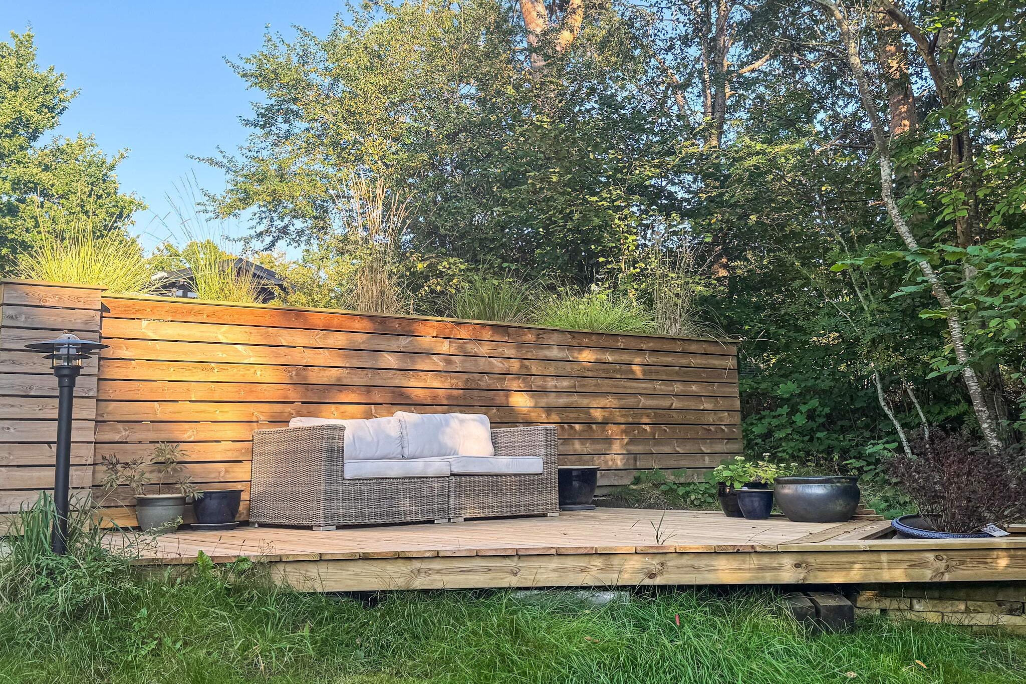 This bright and spacious holiday home offers modern comforts and is perfect for a relaxing stay, accommodating up to 6 guests within its generous 120m². The house features a welcoming open-plan living area with a TV equipped with Chromecast, ideal for streaming entertainment. The kitchen is fully equipped with modern amenities, including a large fridge/freezer, microwave, induction hob, coffee maker, and a dishwasher, ensuring effortless meal preparation during your stay.
The villa provides comfortable sleeping arrangements with three well-appointed bedrooms: two rooms are furnished with double beds (1DS each), and the third room contains two single beds (2S). For convenience, the house features two full bathrooms, each with a toilet, sink, and shower. A separate utility room (Bryggers) houses a washing machine. For year-round comfort, the house is heated by electric heating and an efficient air-to-air heat pump.
Outdoor living is a highlight, with the property set on a large 1200 m² natural plot. Guests can relax on the terrace or the covered terrace, furnished with garden furniture and sun loungers. The outdoor area is perfect for socializing, featuring a gas grill and an outdoor fireplace for cozy evenings. The location is convenient, situated in a holiday home area with the beach 1.2 km away, a restaurant at 895m, and town access within 2.0 km. Please note the house is not rented out to youth groups or craftsmen groups.