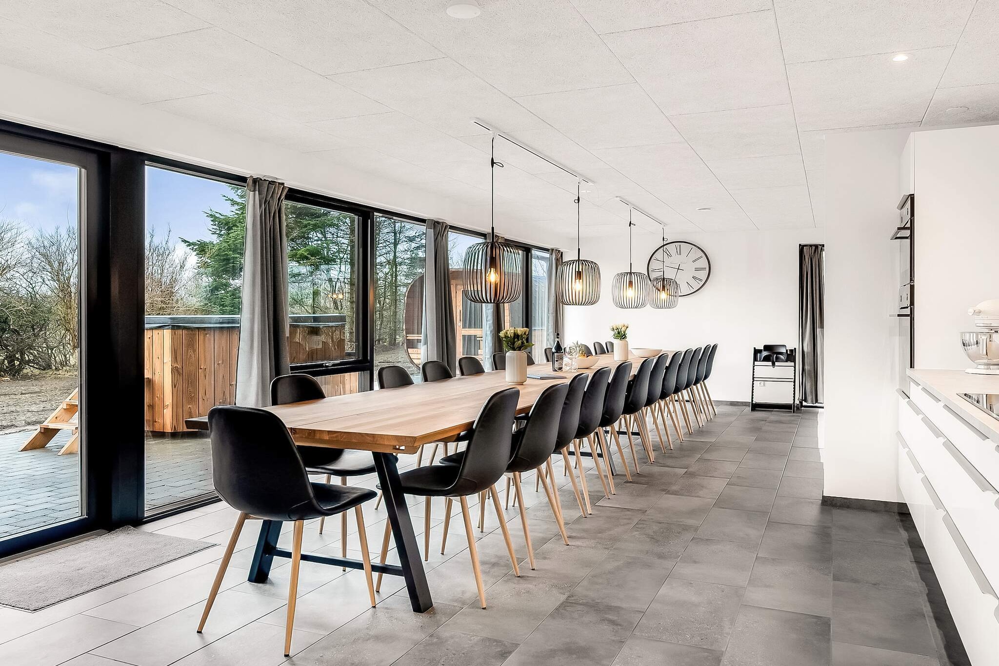 At Vedersø Klit, you will find this completely renovated summer house (2023) with an eye for detail, located on a 3700 m2 plot with activities for the whole family, both indoors and outdoors. The house also offers a brand new luxury wilderness bath with lights and bubbles with room for 14-16 people, as well as a huge sauna barrel with room for 12-14 people.
The garden offers ample opportunity to enjoy your vacation in peace and quiet, with opportunities for play and activities for the whole family, as well as enjoying the sun from several cozy areas, including 5 hammocks.
The house is heated with an energy-efficient air/water heat pump and there is a ventilation system with a heating plate, which provides a fantastic indoor climate, as well as a pellet stove (exclusive 6 mm wood pellets - must be brought yourself). There is underfloor heating in the bathrooms. In addition, there is a charging station for electric cars (Type 2) with a 7 m cable.
The house is an activity house with plenty of entertainment for the whole family, including table football, billiards, table tennis, electronic darts, outdoor beach volleyball, hammocks, a soccer field, and mini golf courses. Please note that mini golf and hammocks are available from approximately April 1 to October 31.
The house's large youth room also invites you to relax, with a PlayStation 4 including games, beanbag chairs, and a 65" smart TV where the kids can stream various TV services.
The holiday home is bright and inviting and is practically furnished with a kitchen/family room/living room. The living room offers modern furniture and a smart TV with German, Danish, and Nordic channels. There is a fully automatic wood-burning stove (with pellets) to spread cosiness and warmth on a cool summer evening or a rainy and windy autumn day.
The kitchen has a large ceramic hob (induction), extractor hood, 2 separate ovens, one of which also functions as a microwave, fridge/freezer with ice cube machine and cold water, coffee machine, mixer, blender, and 2 dishwashers. There is seating for up to 28 people at the dining table.
There are two bathrooms, both with underfloor heating, and there is also a washing machine and dryer.
The cottage has nine bedrooms, all with new luxury beds, including six rooms with double beds, two rooms with two single beds, and one room with two "Norwegian bunks" that can accommodate six people. In addition, there is a double bed in the living room.
There is free high-speed fiber internet throughout the house (1000/1000 Mbit).
The house offers an open terrace with an outdoor kitchen consisting of a grill, sink, gas burner, griddle, etc., where you can enjoy dinner while watching the sun set over the area.
On the terrace, you will also find the house's large wilderness bath/jacuzzi, which is heated by electricity and therefore always ready for use. The wilderness bath is a natural gathering place for the whole family. In addition, there is a large sauna barrel with room for 12-14 people and an outdoor shower.
Not available for rent to youth groups or construction crews.