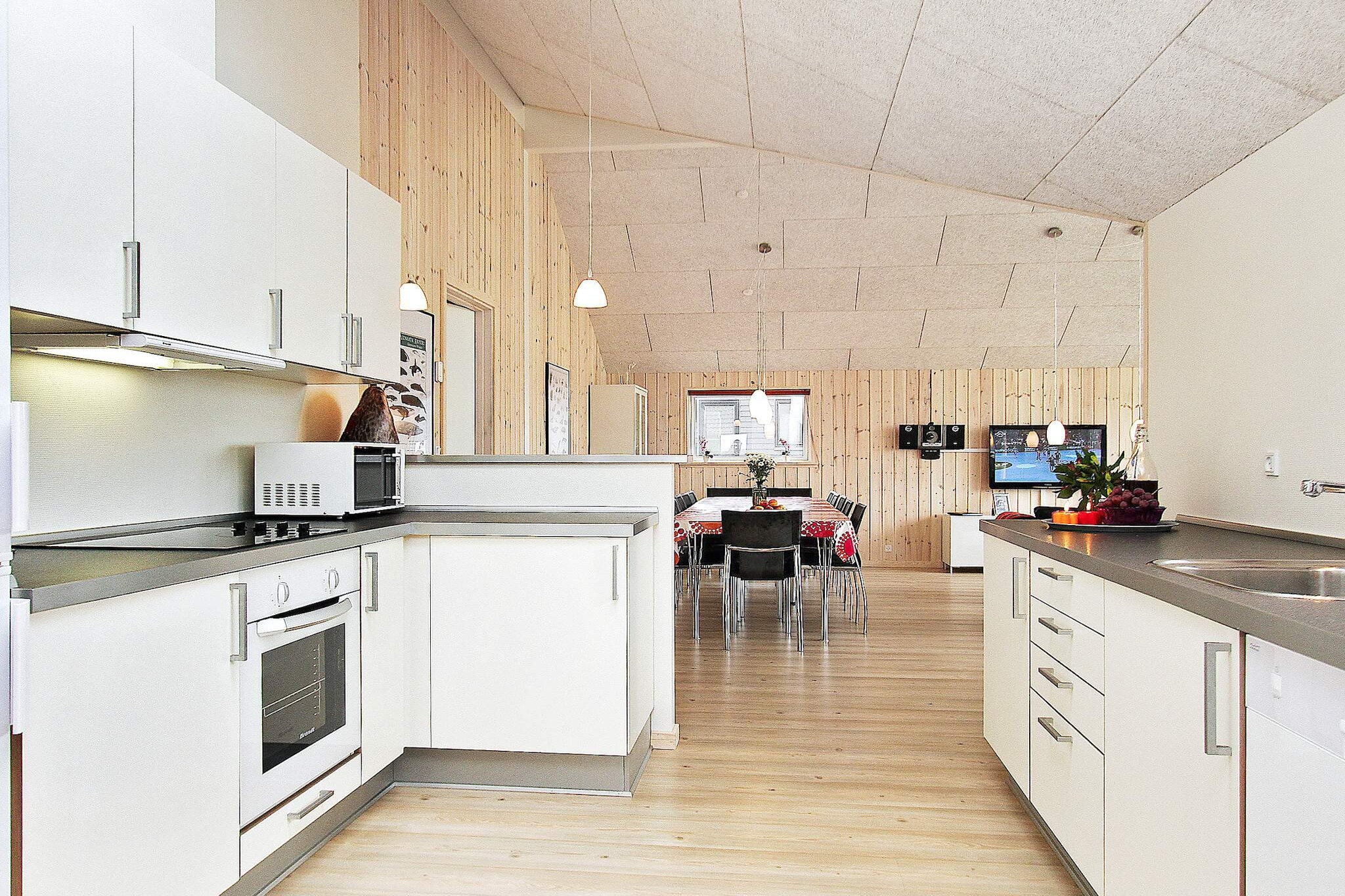 Kitchen(cooker(electric), coffee machine, microwave, dishwasher, fridge-freezer, high chair), Living/bed room(TV(german television channels, danish TV channels (DR1 and TV2), norvegian TV channels , swedish TV channels), stereo unit), bedroom(2x double bed, children\'s bed), bedroom(2x single bed), bedroom(2x single bed), bedroom(2x single bed), bedroom(double bed), bathroom(tumble dryer, washbasin, shower, toilet, washing machine), bathroom(washbasin, shower, toilet), mezzanine(4x single folding bed), game computer, Bubble bath(indoor, heated, 6 persons), sauna(indoor, 6 persons), heating(electric), garden furniture, swimming pool(indoor), play equipment, table tennis table, table football, darts, billiards, air to air heatpump