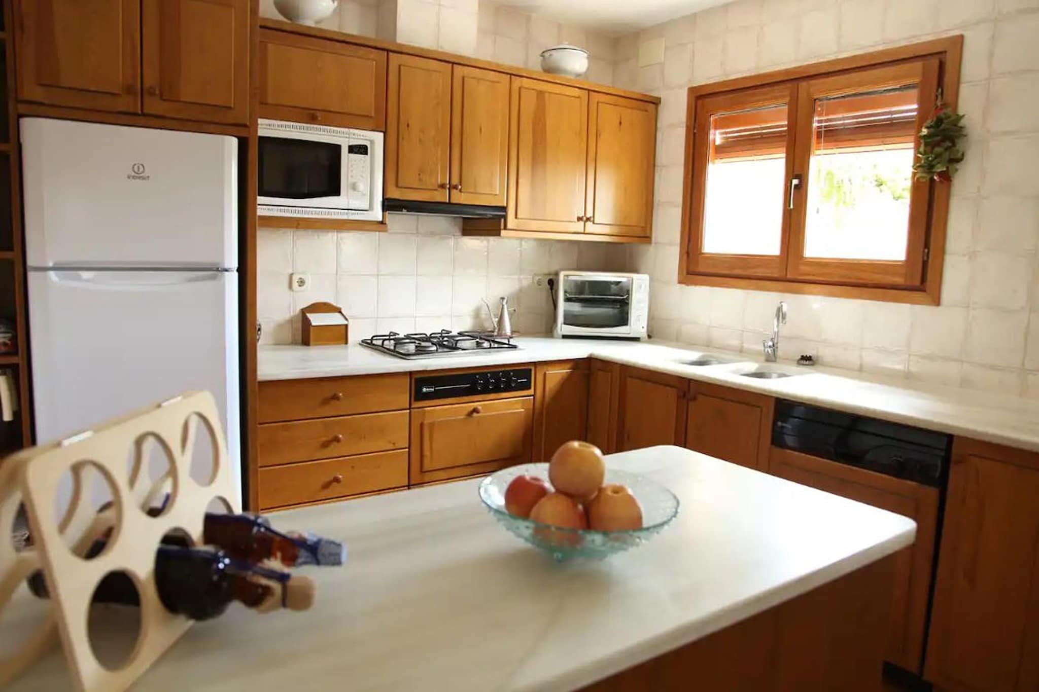 Ground floor: (Entrance, open kitchen(hob, boiling water tap, toaster, hood, coffee machine, oven, microwave, dishwasher, fridge-freezer, Juicer), Living/diningroom(TV(flatscreen), dining table, fireplace, seating area), bedroom(single sofa bed, double bed), bedroom(single bed, single bed), bathroom(bathtub with shower, washbasin, toilet, hairdryer), heating, terrace)\n\nOn the 1st floor: (Bedroom with bathroom(single bed, double bed, bathtub with shower, washbasin, toilet, hairdryer), Bedroom with bathroom(double bed, bathtub with shower, washbasin, toilet), heating, air conditioning)\n\ntoilet(washbasin, toilet), relaxation area(reachable from the outside), dining table, terrace(private), garden(shared with other guests, illuminated), garden furniture, sun loungers, BBQ(charcoal), parking, parasol, swimming pool(shared with other guests, outside, opened from May upto and including Sep), football goal(shared with other guests), hammock, hammock, high chair