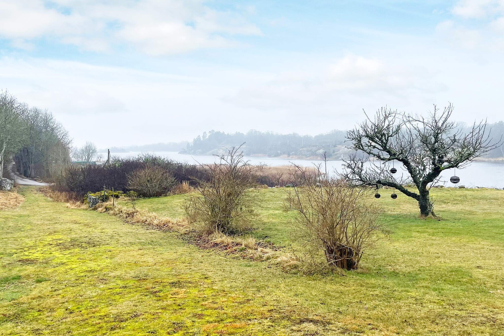 "Welcome to "Villa Martina", named after a former faithful guest of this house. The house has a fantastic view of Risanäsviken from the patio at the back. A cup of coffee in the morning sun on the wooden deck or dinner around the table under the shelter of the roof on the patio is lovely. At bathrobe distance from the house, swimmers can take a dip from the jetty and within a few kilometers there are several child-friendly sandy beaches in Saxemara and Ekenäs. The house has an open floor plan with a stove to burn in for lovely warmth and increased coziness factor, firewood is included. Sofa bed and armchairs to sit in for community in the airy family room with high ceilings. Kitchen with all the possibilities for self-catering and a dining table to gather around if the weather does not permit sitting outside on the privacy-protected south-facing balcony, furnished with a dining area and sun loungers. From here a staircase down to a large lawn with trees available for play and activity. A bedroom on the lower level with a double bed and a window facing the sea. The bathroom is equipped with a shower and washing machine. The loft stairs to the upper floor with two beds can feel steep and are not suitable for everyone. A child gate from below is available for some safety. In Saxemara there is a summer-open cafe with some basic goods in the range and the proximity to Ronneby with shopping, restaurants and other services is good. Old, ancient Ronneby Brunn with park offers events such as concerts, exhibitions and a large flea market every Sunday during the summer. There are also pools with an outdoor waterslide and a spa with an indoor hot tub. The boat traffic from the inner city through Ronnebyån out to the harbor and the islands is a pleasant experience. There are several daily trips in the summertime out into the archipelago from various harbors to picturesque places for swimming and excursion destinations that can be recommended. Walks and bike rides on narrow winding roads provide a wonderful nature experience in beautiful, green Blekinge, also called "Sweden's garden". Good to know Firewood is not included.