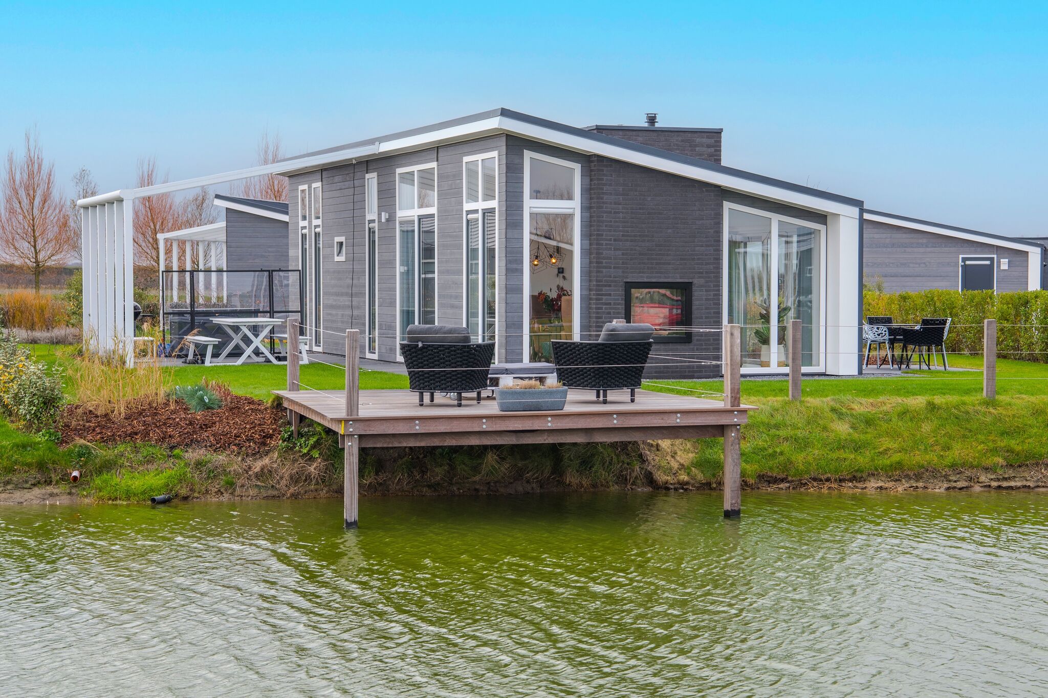 Modern chalet on the water at a holiday park