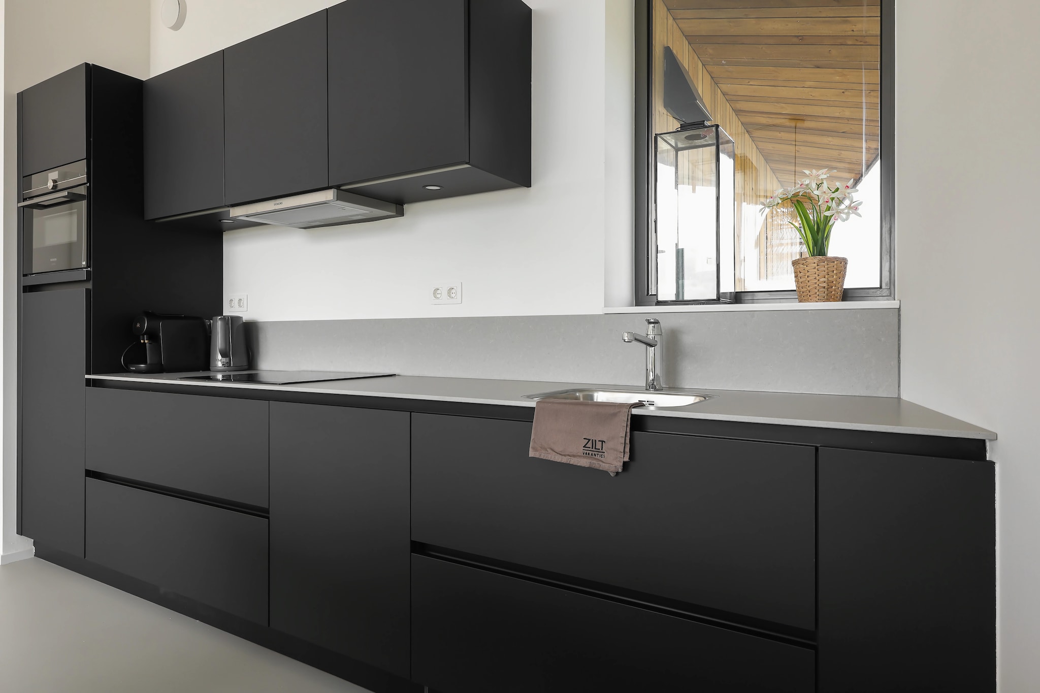 Ground floor: (Kitchen(cooker, coffee machine, oven, dishwasher, fridge), Living/diningroom(TV, seating area), bedroom(double bed), bedroom(double bed), bedroom(bunk bed), bathroom(shower, washbasin, toilet), toilet(toilet))\n\nterrace, garden, parking