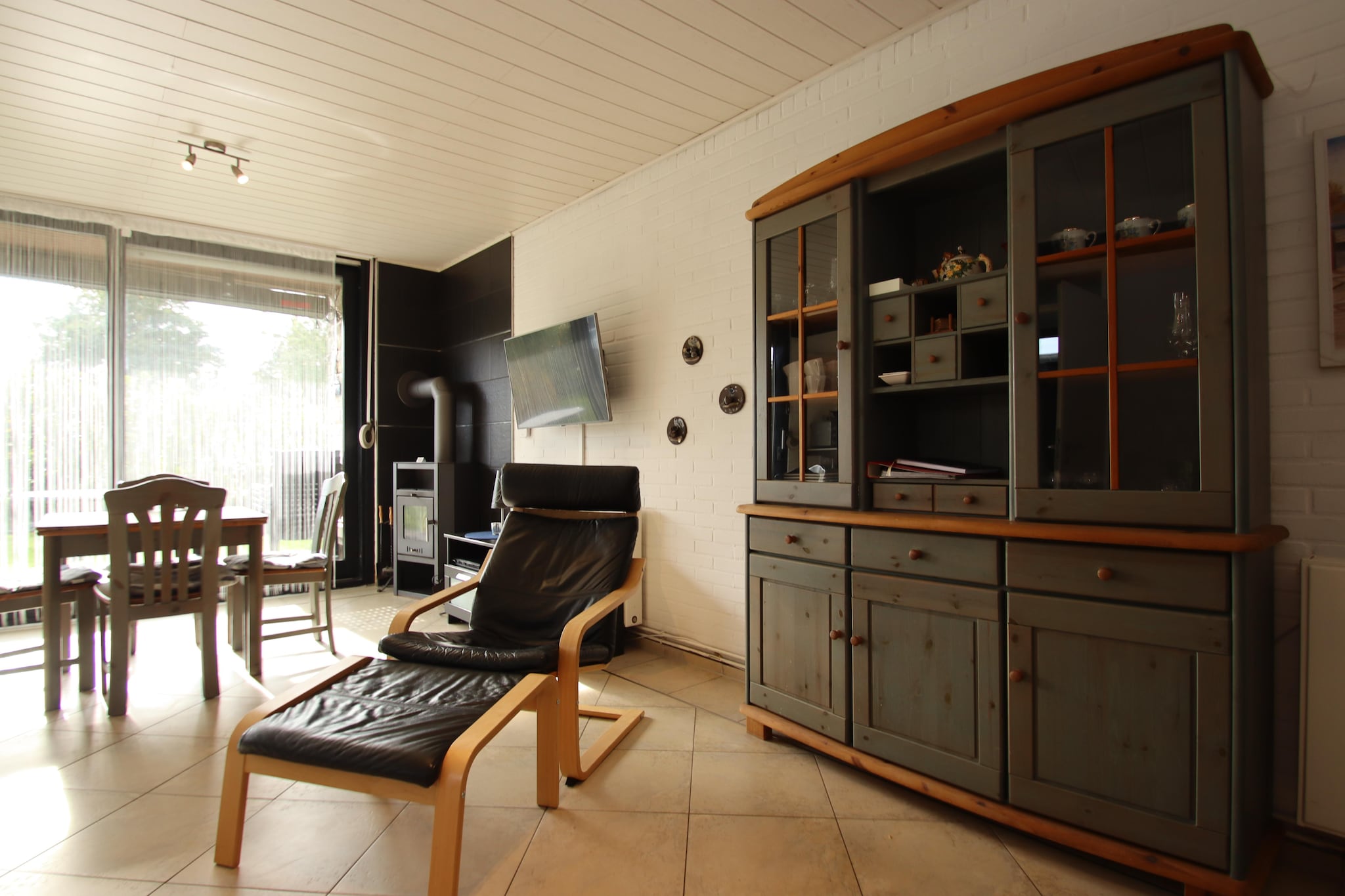 Ground floor: (open kitchen(electric kettle, toaster, cooker(electric), coffee machine, microwave, dishwasher, fridge-freezer), Living/bed room(double sofa bed, TV, dining table, Blu-ray player, radio, CD player), bedroom(double bed(180 x 200 cm)), bathroom(shower, washbasin, toilet))\n\nfireplace, terrace, garden, bicycle storage, garden furniture, sun loungers, BBQ, parking, sand pit, play equipment, slide, high chair, Swing set, baby crib(free), Laundry Package for a fee