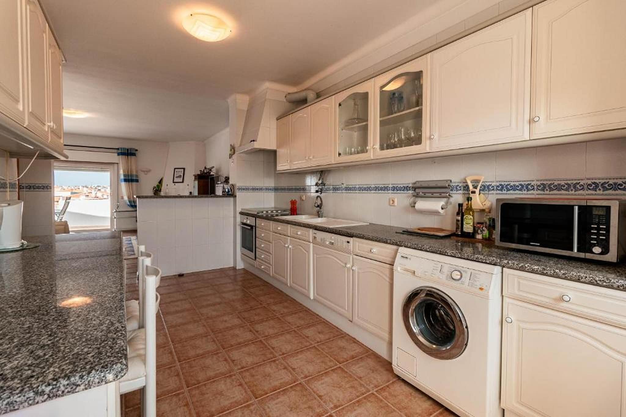 Ground floor: (Entrance(shared with other guests, reachable from the outside))\n\nOn the 3rd floor: (Entrance, Large kitchen(hob, electric kettle, toaster, hood, coffee machine, oven, microwave, dishwasher, fridge-freezer, washing machine), Living/diningroom(TV(flatscreen, satellite, international television channels), fireplace, seating area, balcony or terrace, air conditioning), bedroom(double bed, air conditioning), bedroom(single bed, single bed, air conditioning), bathroom(bathtub with shower, washbasin, toilet, bidet), bathroom(shower, washbasin, toilet), balcony or terrace)\n\nparking, ironing board, iron, hairdryer