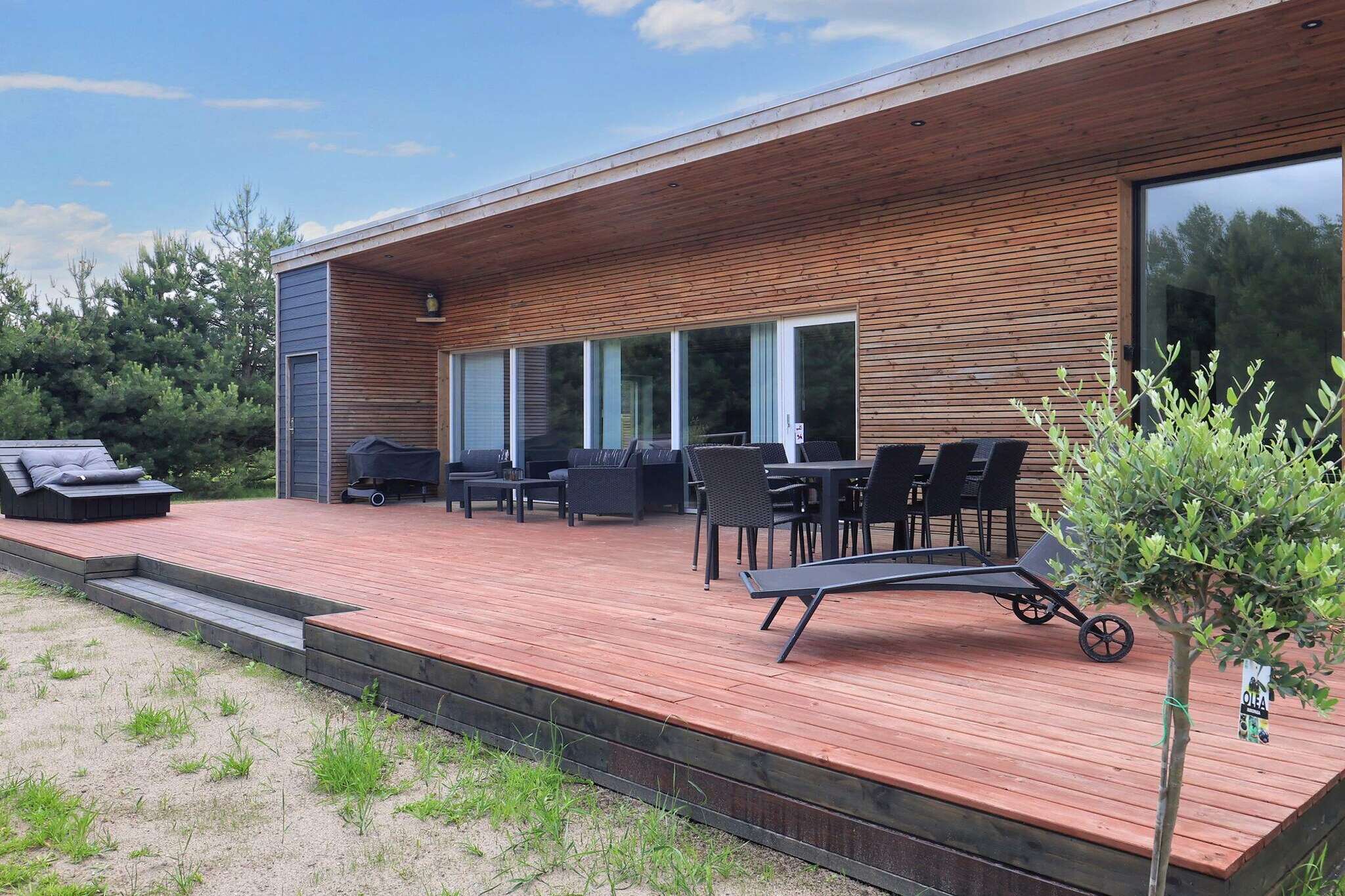 In Marielyst, you will find this modern and cozy, well-appointed 122 m2 holiday home from 2020, located on a large 1200 m2 natural plot, 1500 meters from one of Denmark's best and most child-friendly beaches. The local grocery store is about 1200 meters away, and Marielyst town center, where there are also shopping opportunities, is about 3 km away.The cozy living room is combined with a modern kitchen, which includes an induction stove, coffee maker, refrigerator/freezer, and dishwasher. The living room has a smart TV and wireless internet, and adjacent to the living room is a foosball table and darts for children of all ages to enjoy.The house has three bedrooms, one with a double bed, the other with a double bed and a TV with Chromecast and PlayStation 4. The third bedroom has three bunk beds, two at the bottom and one at the top.The bathroom has a toilet, sink, and shower. The house is heated by an air/water heat pump that provides heat for the underfloor heating and radiators.From the living room, you have direct access to the lovely wooden terrace with garden furniture, sun loungers, and a charcoal grill. Large natural grounds with a play frame and soccer goals, as well as a fire pit and space for many other games in the garden. Not available for rental to youth groups.A refundable deposit might be charged closer to your check-in date. The security deposit ensures a smooth stay and covers any additional services or consumption charges.This deposit covers utilities consumed during your stay and any additional services that may be taken.The final amount will be adjusted based on actual meter readings, actual usage of extra services, and any remaining balance will be refunded within 21 days after checkout.This deposit simply acts as a prepayment for charges that  you would anyways pay for, ensuring a seamless stay and check-out experience.