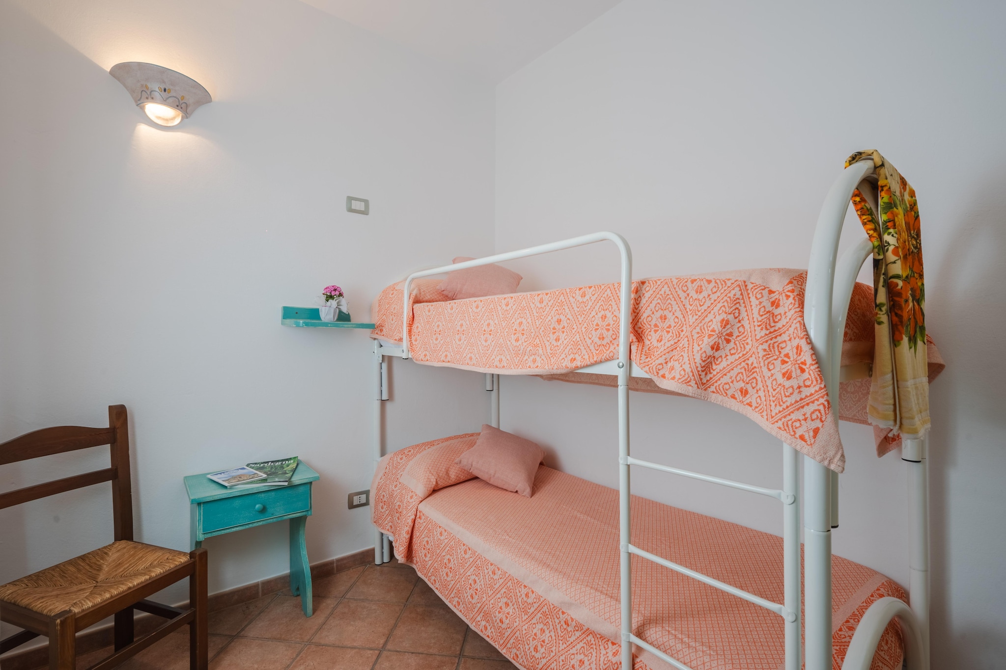 Ground floor: (Living room(double sofa bed, TV, dining table, seating area, air conditioning), open kitchen(hob, hood, oven, fridge-freezer), bedroom(double bed), bedroom(bunk bed), bathroom(shower, washbasin, toilet, bidet, washing machine), veranda(dining table))\n\nparking