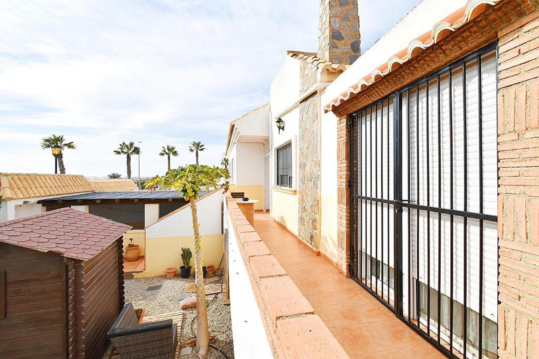 Ground floor: (Entrance(reachable from the outside), open kitchen(hob, hood, coffee machine, oven, microwave, fridge-freezer), Living/diningroom(TV(flatscreen), dining table, fireplace, seating area), bedroom(double bed), bedroom(double bed), bedroom(single bed, single bed), bedroom(bunk bed or 2 single beds), bathroom(bathtub with shower, washbasin, toilet, bidet), air conditioning, terrace, heating)\n\ngarage, garden doors, patio, garden furniture, ironing board, iron