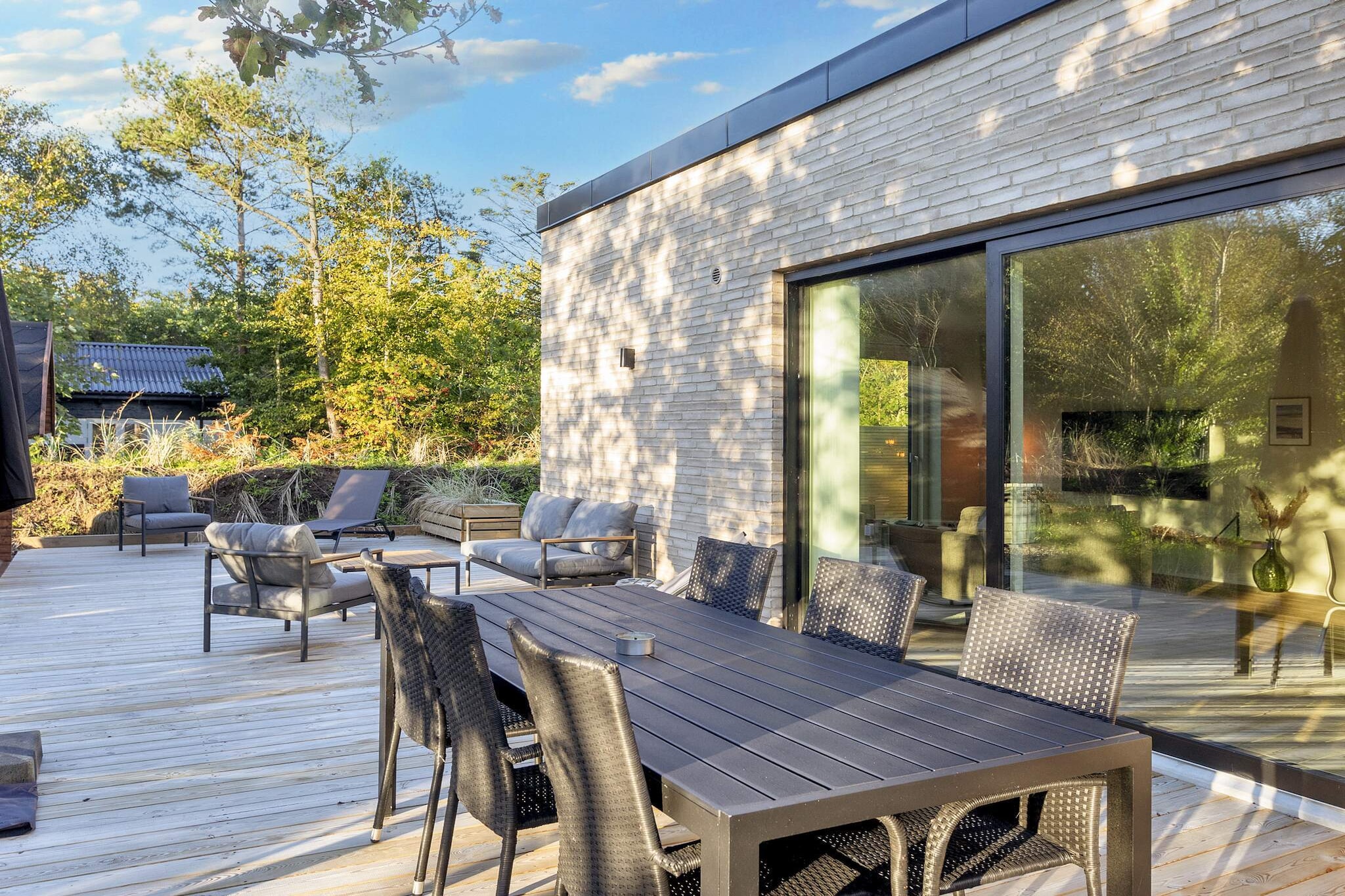 This newly built holiday home, completed in 2024, is located in Agger and accommodates up to 8 guests. The house features 4 bedrooms (2 with double beds and 2 with single beds) and 2 bathrooms, making it ideal for families or small groups looking for space and comfort. The home offers modern amenities including a fully equipped kitchen with a dishwasher, a smart TV for your own streaming services, Wi-Fi, washing machine, tumble dryer, and underfloor heating throughout. Outside, you'll find a spacious terrace with sun loungers, a gas grill, a wood-fired hot tub for 4 people, and a private sauna — perfect for relaxing after a day in nature. Situated near the North Sea and within reach of Flade Lake and Thy National Park, the house offers excellent opportunities for hiking and enjoying the beautiful Danish landscape. This is a non-smoking house and is not rented to youth or work groups, ensuring a quiet and restful atmosphere.A refundable deposit might be charged closer to your check-in date. The security deposit ensures a smooth stay and covers any additional services or consumption charges.This deposit covers utilities consumed during your stay and any additional services that may be taken.The final amount will be adjusted based on actual meter readings, actual usage of extra services, and any remaining balance will be refunded within 21 days after checkout.This deposit simply acts as a prepayment for charges that  you would anyways pay for, ensuring a seamless stay and check-out experience.