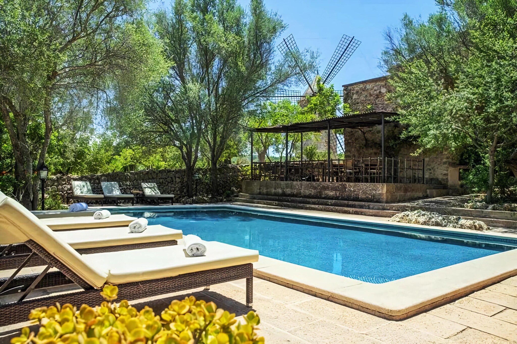 The property is wonderfully located in the middle of a Mallorcan winery on the outskirts of Santa MarÃ­a. The old restored mill in front of the farm is a real eye-catcher! The house itself offers around 250 mÂ² of living space spread over two floors, a total of 4 double bedrooms (three with 2 single beds each and 1 with double bed), four bathrooms (all en suite), all bedrooms have their own air conditioning, living-dining room with satellite TV, WiFi and kitchenette with dishwasher.  

A guided tour and tasting during your vacation. The town of Santa MarÃ­a is located in the north of the capital Palma de Mallorca and has since become an ideal starting point for all directions of the island. There is a motorway connection nearby. The nearest supermarkets in Santa MarÃ­a or Marratxi are just a stone's throw away. Just a few minutes by car. For more extensive shopping, you can reach the capital Palma in just a few minutes (15 km). For those looking for special offers or just wanting to spend a fun afternoon with the family, we recommend the Mallorca Fashion Outlet shopping center, just 6 km away. By the way: this property can be combined. Perfect with another ranch (up to 8 additional guests) located on the same property, just a few minutes away. Hundreds of meters away. Ask us about this. 

From the living room you have access to the magical garden laid out like a small forest and therefore offers plenty of shade. Here you will also find the large private pool salt water and the covered terrace to sit right next to it. A dream place to quickly forget the stress of everyday life. There is a mobile barbecue and plenty of parking in the garden.  

The owner family produces their own wine on this huge 26 hectare estate so you can enjoy.