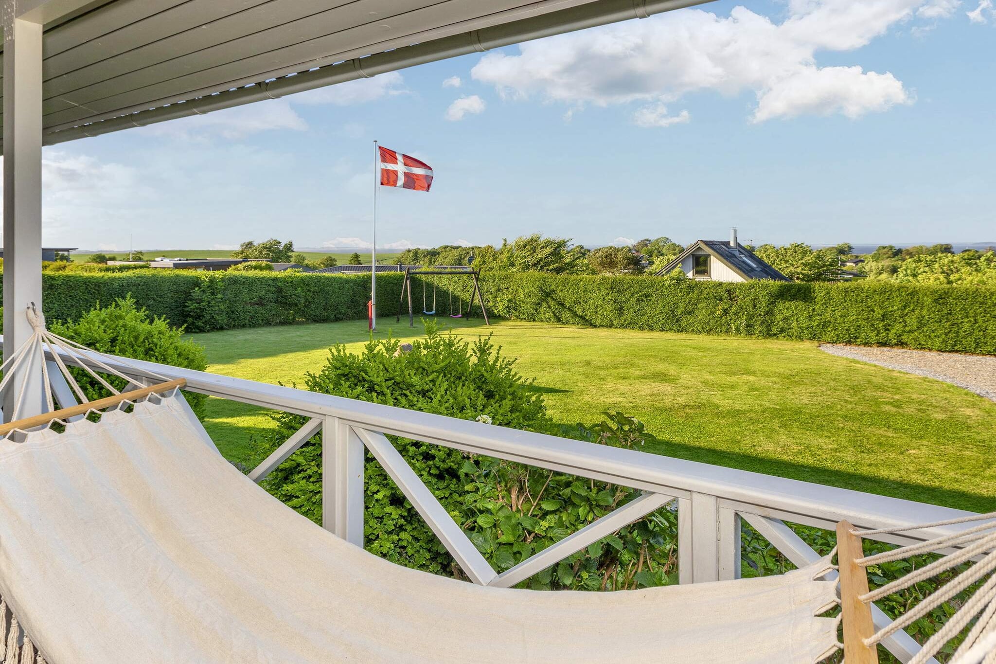 Attractively located, traditional vacation home with a beautiful view of the water in the Limfjord! Located only about 350 m from the fjord shore with a child-friendly beach and jetty. The property offers plenty of space to enjoy the outdoors and play. The bright and invitingly furnished vacation home is practically equipped with a combined living/dining room and kitchen. The kitchen provides access to the rear terrace. The living room offers free WiFi, a flat-screen TV with Chromecast for streaming your own TV providers, and a wood-burning stove for cooler evenings. A climate-friendly heat pump is also available. The kitchen has a stove, extractor hood, microwave, coffee machine, fridge/freezer, and dishwasher. Bathroom with shower, toilet, and pleasant underfloor heating. The vacation home has three bedrooms to choose from: 1st room with a double bed (160x200 cm), 2nd room with bunk beds with two berths (90x200 cm), 3rd room with a single berth (90x200 cm). There are two covered terraces outside so you can enjoy the view in any weather. Relax in the hammock or on the garden furniture. There is a gas grill at the house. DanCenter does not provide any service or warranty for the garden trampoline and bicycles. These can only be used at your own risk. No rental to youth or craftsmen groups desired!For family vacations only.A refundable deposit might be charged closer to your check-in date. The security deposit ensures a smooth stay and covers any additional services or consumption charges.This deposit covers utilities consumed during your stay and any additional services that may be taken.The final amount will be adjusted based on actual meter readings, actual usage of extra services, and any remaining balance will be refunded within 21 days after checkout.This deposit simply acts as a prepayment for charges that  you would anyways pay for, ensuring a seamless stay and check-out experience.