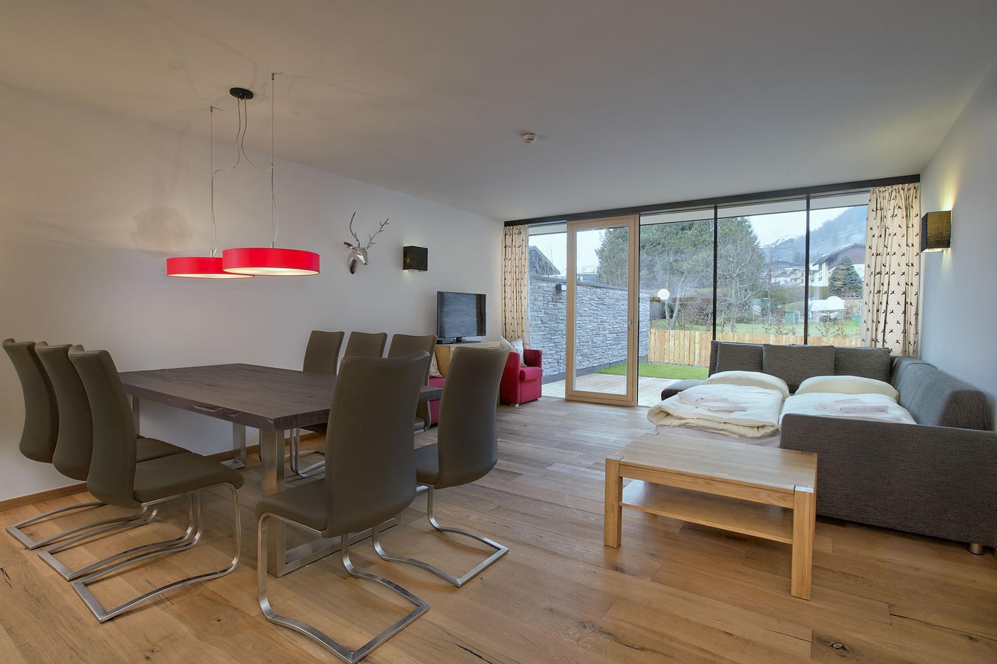 This modern apartment is in Neukirchen am GroÃŸvenediger near the ski area. The property has 3 bedrooms and is perfect for 8 people. The apartment has a sauna for you to unwind after a long tiring day.



The local grocery store is only 300 m away, if you run out of your essentials. The apartment is only 100 m from the ski lift and ski bus if you would like to spend some time in the snow. The nearest restaurant is also 200 m from the stay. The lake lies 8 km from the apartment.



The terrace is the perfect spot in the apartment where you can enjoy your evening cuppa with your dear ones. You can stay comfortable inside from the heat with the floor heating available. Ski boot heaters, lift and the garage is provided for your convenience. A cot and high chair can be availed at a nominal fee for the young guests.





The guests can check-in from 4-6 PM and check-out can be done from 9-10 AM.