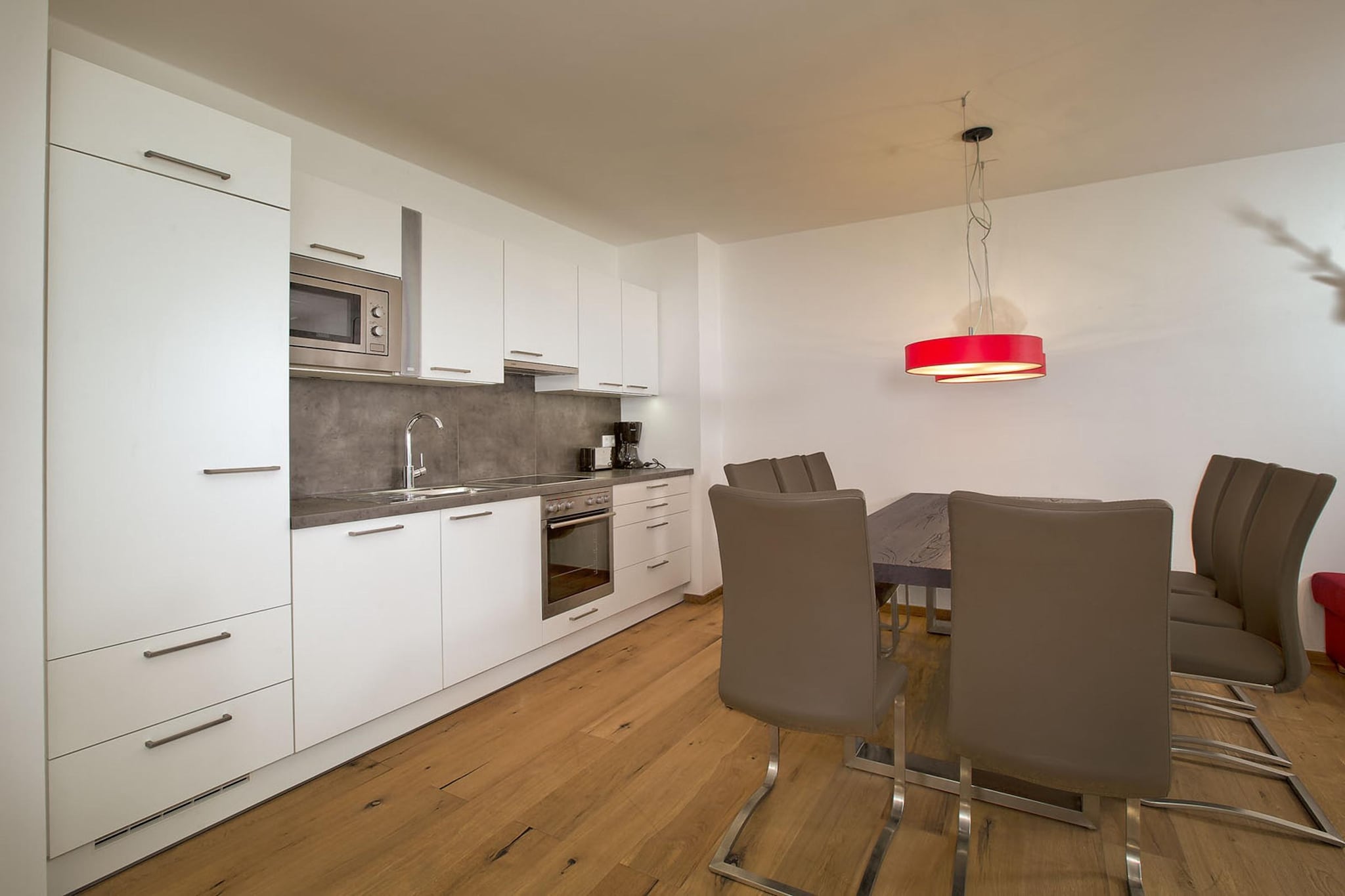 Ground floor: (Living room, open kitchen(cooker(ceramic), oven, dishwasher, fridge-freezer), bedroom(double bed), bedroom(double bed, TV), Bedroom with bathroom(double bed, bunk bed, shower, washbasin, toilet), bathroom(shower, washbasin, toilet))\n\nsanitary facility(tumble dryer(shared with other guests), washing machine(shared with other guests)), relaxation area(shared with other guests)(shower, massage shower, sauna, toilet), garage, ski boot heaters, balcony or terrace, heating(Floor heating), lift, safety deposit box