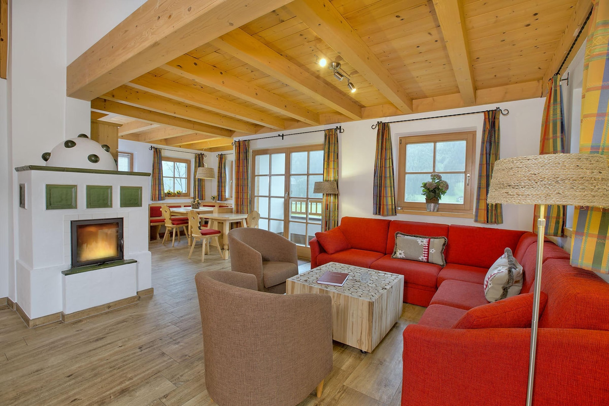 This peaceful chalet is situated in Königsleiten. Ideal for a group, it can accommodate 12 guests and has 5 bedrooms. It also has a swimming pool for you to have a relaxing time at the chalet.
The chalet is only 200 m from the ski bus making it perfect for the sea lovers. The local grocery stores are 500 m from the stay. Try some local delicacies at the restaurant nearby, just 100 m away.
You can relish a lovely cup of coffee on the balcony with your dear ones. You can park your vehicles in the parking provided. A terrace is also accessible for you to enjoy delicious meals with your dear ones. Central heating and fireplace are provided for you to have a gala time with your family. This property also offers high chair and cot for a small fee for the comfort of the tiny guests.
You can check-in from 4-6 PM whereas the check-out timing is 9-10 AM.