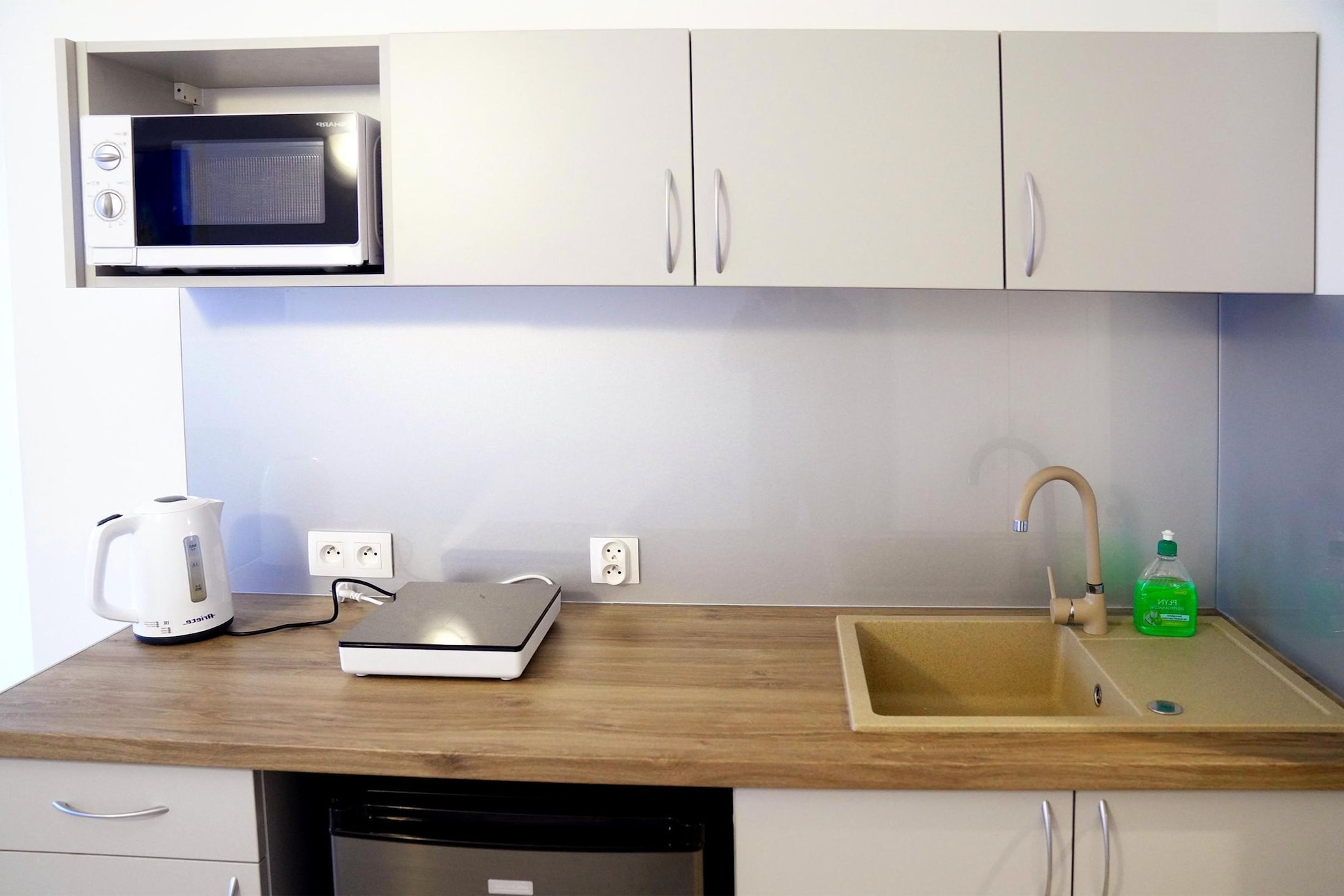 On the 1st floor: (open kitchen(electric kettle, boiling water tap, cooker(1 ring stove, induction), espresso machine, microwave, fridge-freezer), Living/bed room(single bed, double sofa bed, TV(german television channels), dining table), bedroom(double bed), bathroom(shower, washbasin, toilet))\n\nbalcony, lift