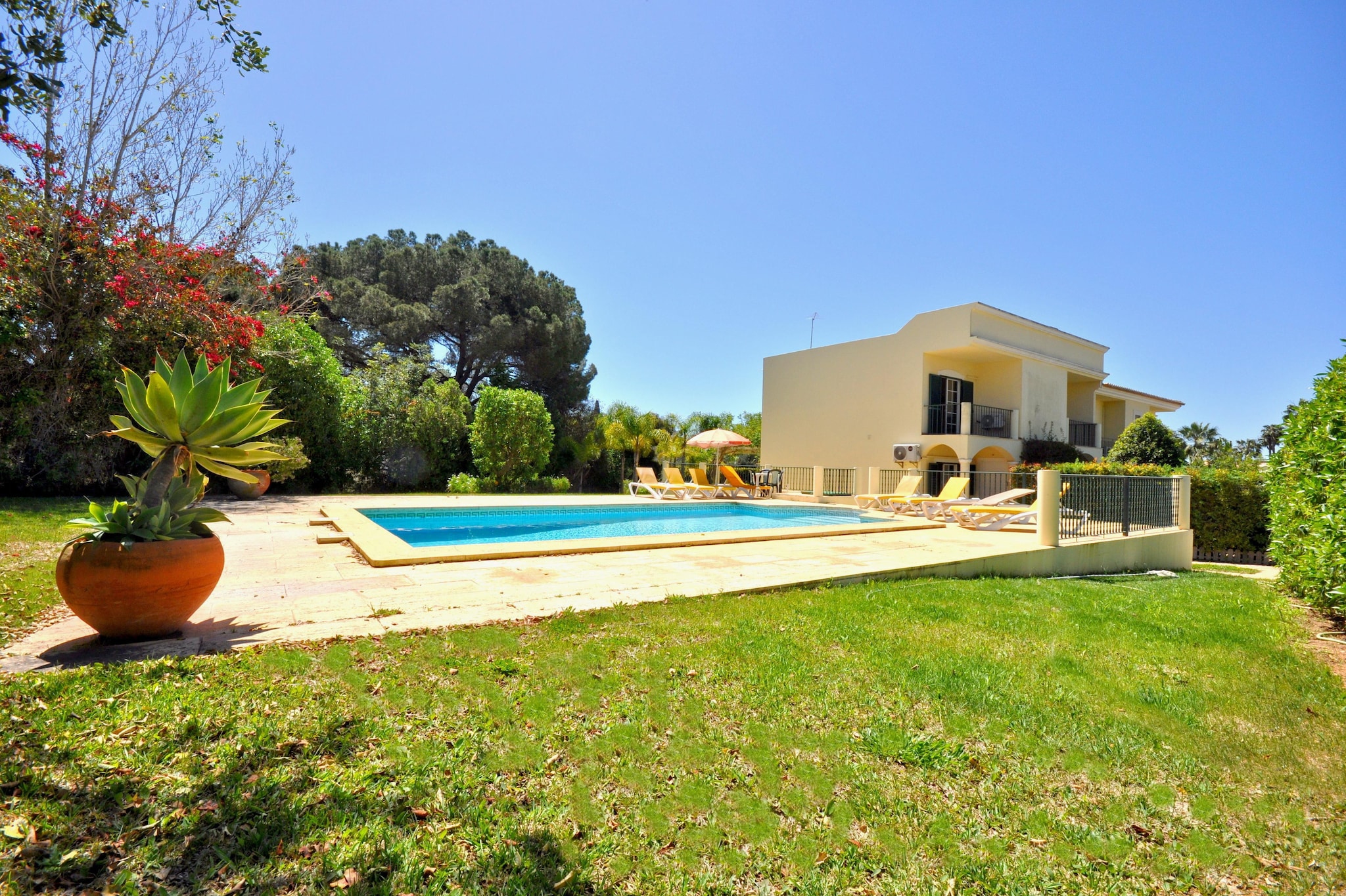 This charming villa is tastefully furnished throughout with comfortable décor and is set in a quiet area of Vilamoura close to the infamous Browns sports club. The bustling marina and vast array of restaurants and bars are just a 10 minute drive away. Beautiful split level gardens surround the villa, complete with a roman style pool and garden furniture.
The accommodation consists of:
Ground floor
- Fully fitted kitchen
- Living / dining room
- Terraced area
- 1 twin bedroom
- 1 bathroom
1st Floor
- 1 double bedroom Suite
- 1 Twin bedroom Suite
- 1 small bedroom with 2 single beds, one being pull-out bed
- 3 bathrooms (2 en-suite)
- Balconies on all bedrooms
Features:
- Private pool (size: 9m x 5m / depth: 1.20m x 2.10m)
- Open poolside shower
- Private garden
- Garden furniture (table, chairs, sunloungers and parasol)
- BBQ
- Microwave
- Washing machine
- Dishwasher
- Microwave
- Smart TV Box
- Cable TV
- Wi-Fi Internet
- Air conditioned (lounge + 3 bedrooms)
- Fan in the small bedroom without A/C
Services Included:
- Gas, water and electricity
- Cleaning service - Arrival, departure and Mid-week
- Bathroom Towels - 2 sets per person, per week
- Linen - 1 set per week
- General maintenance of the villa, pool and garden inc. (mandatory)
Distances:
- Restaurant / Bar / Cafe, 550metres
- Sports & Leisure club, 550metres
- Supermaket, 750metres
- The Old Course Golf Club, 750metres
- Falésia Beach, 3.8kms
- Marina/Centre of Vilamoura 4kms
- Airport, 22kms