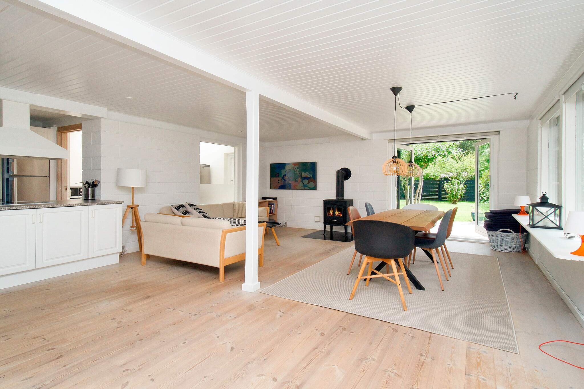 This vacation home is bright and airy, as the living room, kitchen, and bar are open plan and have light from all four sides. The hallway has two double wardrobes and access to the two bedrooms and the large bathroom.

Designed so that the whole family can be together and do different things at the same time. Two chefs can take care of the food; one in the kitchen, the other out in the lovely, bright utility room. There are two refrigerators in the house. You can play board games or enjoy a drink in the high bar stools, relax on the daybed, and watch TV on the sofas. Afterwards, you can enjoy a good dinner indoors or outdoors on the large covered terrace. UTILITY ROOM Brewery, OUTDOOR AREA has sun loungers, and the living room has a smart TV.

The spacious bathroom is accessible from the entrance. If you sleep in the two bedrooms accessible from the entrance area, you will not be disturbed by the hustle and bustle in the living room and kitchen. All three bedrooms have large windows overlooking the beautiful garden. All windows are equipped with blackout curtains.

The garden, which is just over 1,200 mÂ², enjoys sunshine from morning to evening and is also completely screened off at a height of at least 170 cm. The house is the last house on a closed holiday home road. There are two parking spaces.

Due to allergies in the owner's family, pets are not welcome!

The house is a non-smoking house and is not rented to youth groups!

A vacation home for multi-generational stays, families, or couples who can enjoy a wonderful vacation together here.

The key box is on the corner by the front door.