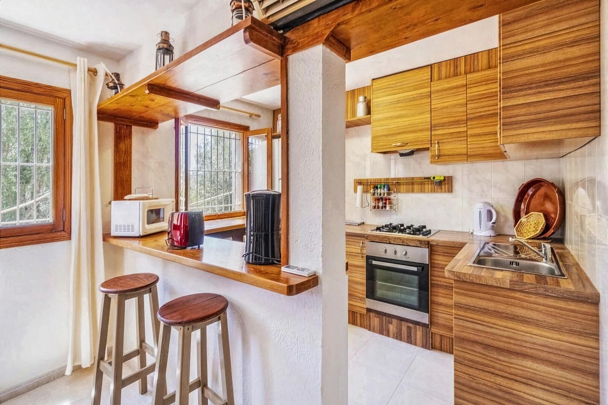 On the 1st floor: (Living room(TV, seating area, air conditioning), open kitchen(dining table, seating area, toaster, cooker, coffee machine, oven, microwave, dishwasher, fridge-freezer, washing machine), bedroom(double bed, air conditioning), bedroom(single bed, single bed, air conditioning), Bedroom with bathroom(double bed, shower, washbasin, toilet, bidet, air conditioning), bathroom(bathtub or shower, washbasin, toilet, bidet))\n\ngarage, seating area, sun shower, solarium, garden furniture, BBQ, swimming pool(private), hammock