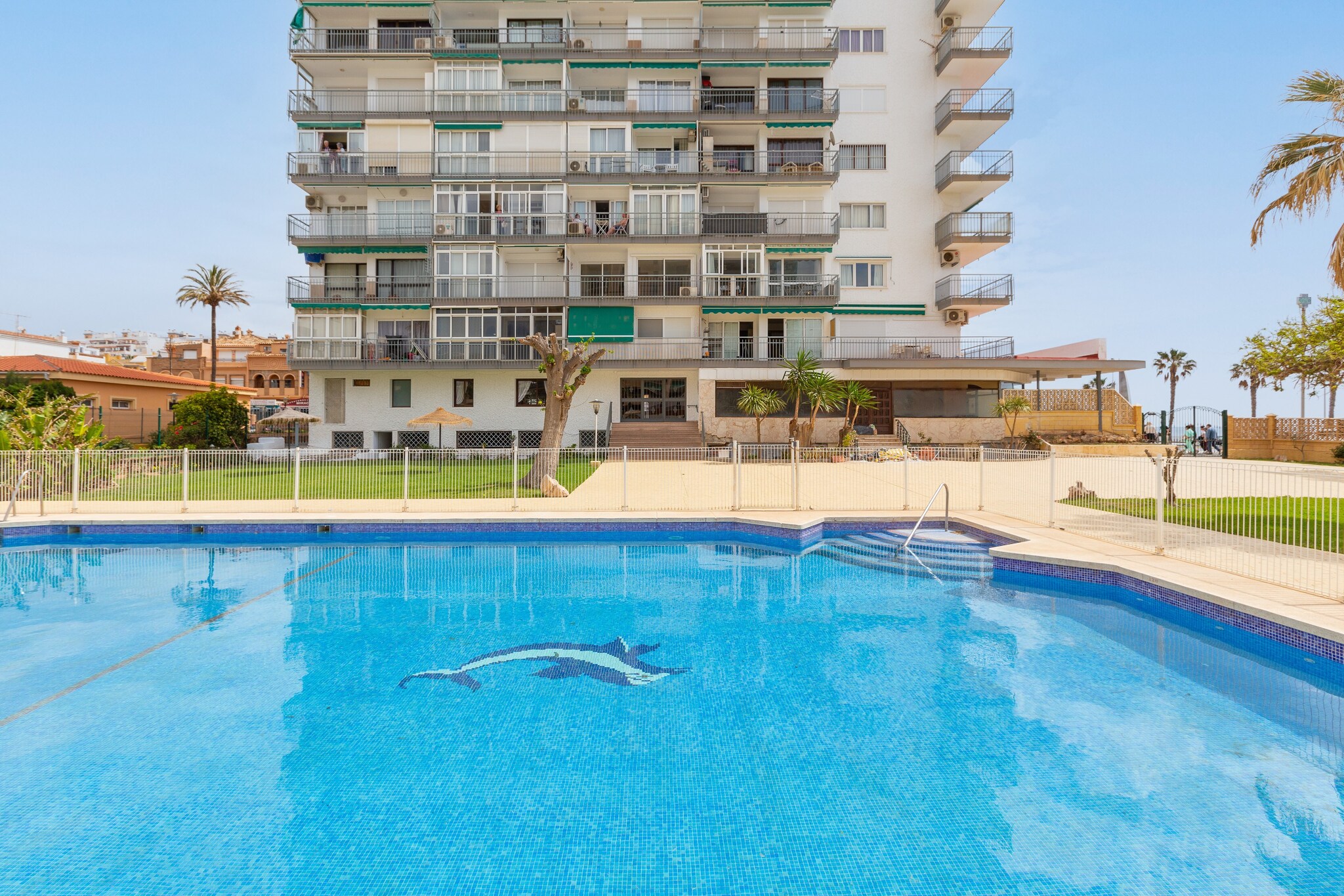 The large and beautiful communal gardens will lead you to an area where you can enjoy several shared swimming pools, one of which is especially for children. The largest measures 18x11m and has a depth varying between 1m and 2.2m. Once at the property, you can enjoy breakfast with sea views from the apartment's balcony. Being located in a building, there are direct neighbours.
The interior of the house, which has been recently refurbished, is designed to give you the rest you deserve. The living-dining room has a TV and AC and is open to the kitchen, equipped with everything you need to cook your favourite dishes. There is also a washing machine, iron and ironing board in the house. When it's time to sleep, there is a cosy double bedroom with a fan. Guests can relax on the sofa bed in the living room. An en suite bathroom with shower and another fan complete the house. If you are travelling with your baby, we can provide you with a cot and a highchair.
The apartment is located in Benalmádena, 140 metres from the Bil Bil beach, a beautiful sandy area next to the castle of the same name with a unique charm. The area has all the necessary services for an independent stay such as supermarkets, bars and restaurants. A few kilometres away is the marina of Benalmádena, one of the most emblematic and most visited places on the Costa del Sol.
The swimming pool is open from April to 30 September from 10:00 to 20:00. Consult the advertiser for possible charges. Pets are not allowed. The holding of events is forbidden.
Distances
Beach: 0.14 km - Playa de Bil Bil
Airport: 14.9 km - Málaga - Costa del Sol
Golf course: 2.9 km - Golf Torrequebrada
Town: 3.9 km - Benalmádena
Train station: 1.8 km - Benalmádena - Arroyo de la Miel
Bus stop: 0.087 km - Av. Las Palmeras
Ferry: 0 km
Hospital: 3.8 km - Hospital Benalmádena
Tourist license: VUT/MA/33988