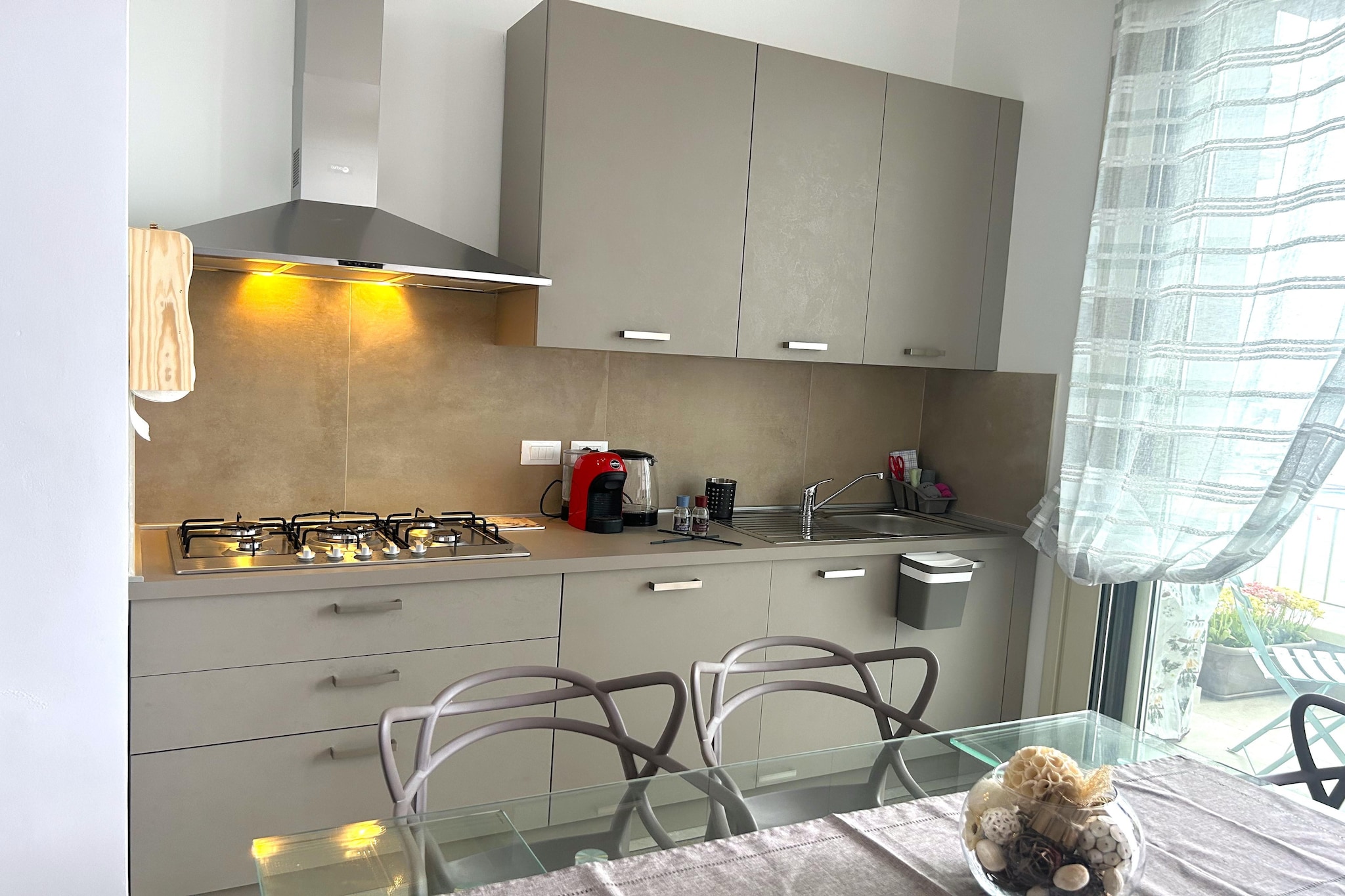 On the 1st floor: (Living room(double sofa bed, TV, dining table, seating area), open kitchen(hob, hood, oven, microwave, fridge-freezer), bedroom(double bed, TV), bedroom(single bed, single bed, TV), bathroom(shower, washbasin, toilet, bidet), balcony, air conditioning)