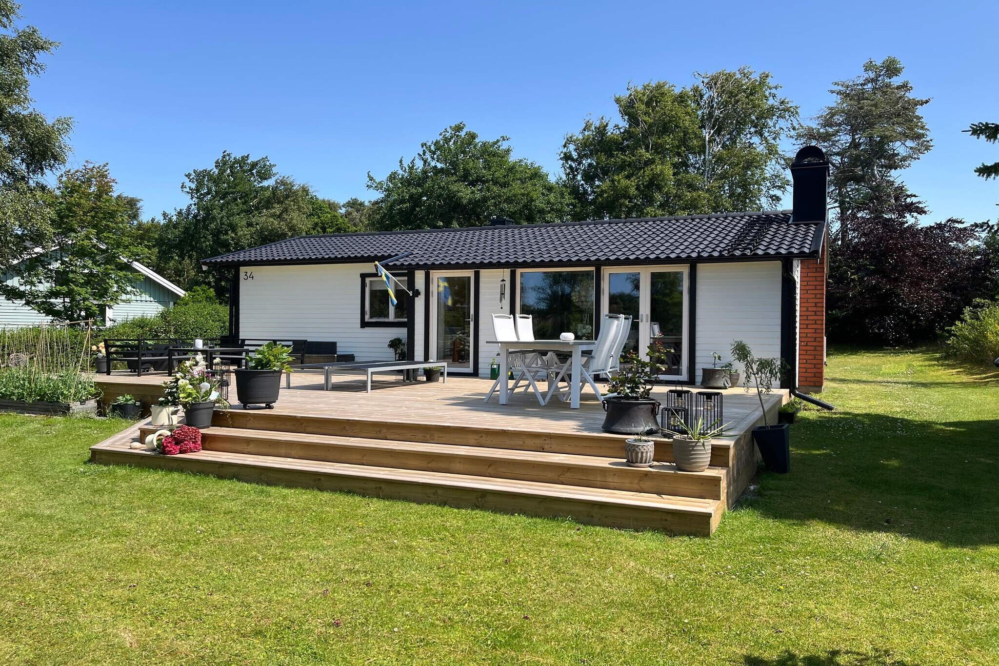 A lovely holiday accommodation in the best location in Mellbystrand. A leafy, privacy-protected plot with a view of the sea and bathrobe distance to the fine sandy beach, the longest sandy beach of Sweden. A tastefully decorated house with lovely patios for both sun and shade. From here you can hear the sea. A perfect accommodation for family or friends who want to holiday together. In front of the house, the lawn can be used as a parking area. The entrance to the house is from the covered terrace at the back. At the entrance there is a bathroom with a shower. There is also a spacious bedroom with a double bed. There are two further bedrooms with two single beds each. The kitchen is well equipped and modern. The generous living room has comfortable seating and a dining area. There is free wifi and a modern TV. From here you come out to a terrace with outdoor furniture and barbecue. In front of the green and fenced plot there is a large green area which gives a pleasant open view towards the sea. On the covered balcony at the back of the house, you have a perfect relaxing and comfortable place for both your morning coffee and your evening meal. The plot has room for all the family's activities. The nice beach is just a short walk away. Put on the bathrobe and take both morning and evening dips. The beach is shallow and child-friendly. Hökafältet, which is nearby, has nice running loops with an outdoor gym and a mountain bike trail. Mellby shopping center is within easy reach. In the area there is the beach hotel, several small shops and restaurants. There is also a popular leisure and exercise area here. To the south you have the Skummeslövstrand summer center. There are also nice cycle paths both to Laholm and Båstad. Discover the Bjäre Peninsula with all its picturesque summer villages and not least Båstad, the wonderful tennis metropolis. Discover Båstad's lovely harbor area and pay a visit to the cold bath house. Just north of Båstad are Norrviken's gardens, a popular destination. You only have a short drive to Laholm. Laholm has a cozy center with small shops, cafes and restaurants. Here Lagan winds around the town and there is fine salmon fishing and a smokehouse with a restaurant. On Hallandsåsen there are also several wonderful hiking trails, tracks for mountain bikes and ski facilities. To the north you can easily reach Halmstad smed with its fantastic beaches in Tylösand, its large range of entertainment and all the golf courses. Laholm's golf club is closest to you. The cottage is not rented out to youth groups.