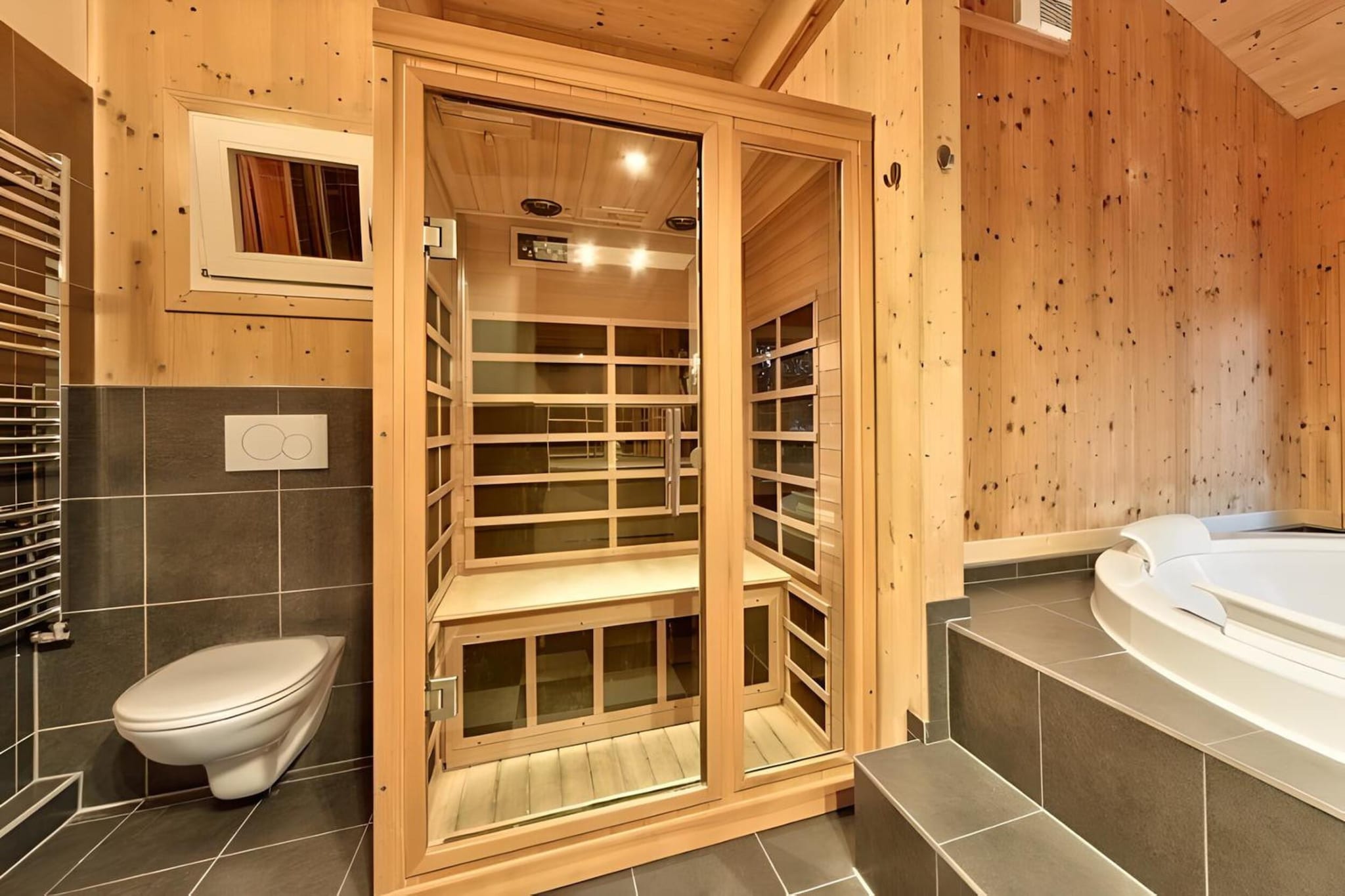 Ground floor: (Entrance, Living room(TV, dining table, fireplace, seating area), open kitchen(hob(4 ring stoves, ceramic), electric kettle, toaster, coffee machine(espresso, filter), oven, microwave, dishwasher, fridge-freezer), bathroom(hot tub, shower, infrared sauna, toilet), Internet access, balcony)\n\nOn the 1st floor: (bedroom(double bed), bedroom(double bed), bedroom(double bed, bunk bed, balcony), bedroom(bunk bed, bunk bed, balcony), bathroom(shower, hairdryer))\n\nbathroom(shower, toilet), ski boot heaters, heating(central), garden furniture, high chair