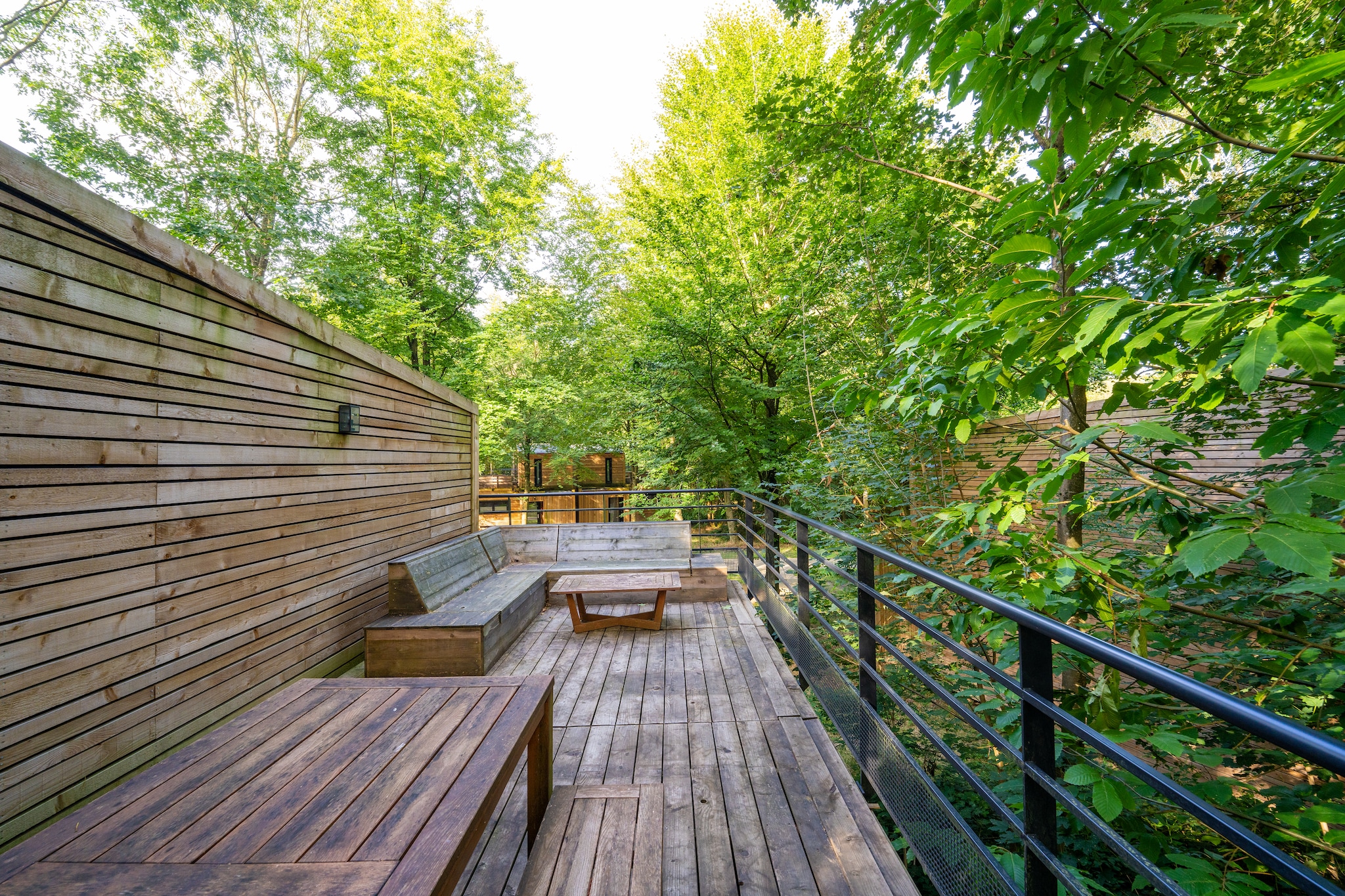 Experience the award-winning charm of Your Nature, a Leisure Award Winning Park, where sustainability meets comfort in a breathtaking natural setting.
Stay at Lushwood, an 85 m² forest retreat in Domaine du Bois de Fouage, perfect for up to four guests. Its warm, nature-inspired design blends effortlessly with the woodland surroundings. The open-plan kitchen includes a fridge, dishwasher, and coffee machine, opening to a spacious dining area.
The ground floor has a cozy bedroom with a double bed and bathroom with shower, while the mezzanine offers a double sofa bed and second bathroom. Enjoy relaxing by the wood fireplace, watching TV, or unwinding on two terraces, one at ground level and one nestled in the trees. Additional perks include electric car charging, bike storage, free Wi-Fi, and access to indoor/outdoor pools, board games, and books. Just 15 km from Tournai and close to Lille, Brussels, Paris, and London, explore hiking or treat yourself to wellness services.
Note: No motorized vehicles on resort roads; golf cars and bikes can be rented. Fishing and swimming are not allowed.