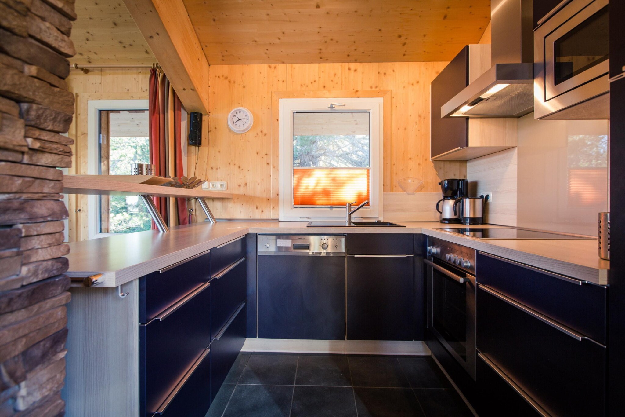 Ground floor: (bedroom(bunk bed, bunk bed), Bedroom with bathroom(double bed, shower, toilet), bathroom(steam shower, toilet), Internet access)\n\nOn the 1st floor: (Living room(TV, dining table, fireplace, seating area, DVD player), open kitchen(hob(4 ring stoves, ceramic), electric kettle, toaster, coffee machine(espresso, filter), oven, microwave, dishwasher, fridge-freezer), bedroom(double bed, balcony), bedroom(double bed, bunk bed, balcony), bathroom(shower, infrared sauna, toilet, balcony, hairdryer))\n\nOn the 2nd floor: (Living room, Kitchen)\n\nbath tub, washing machine, ski boot heaters, heating(central), garden furniture