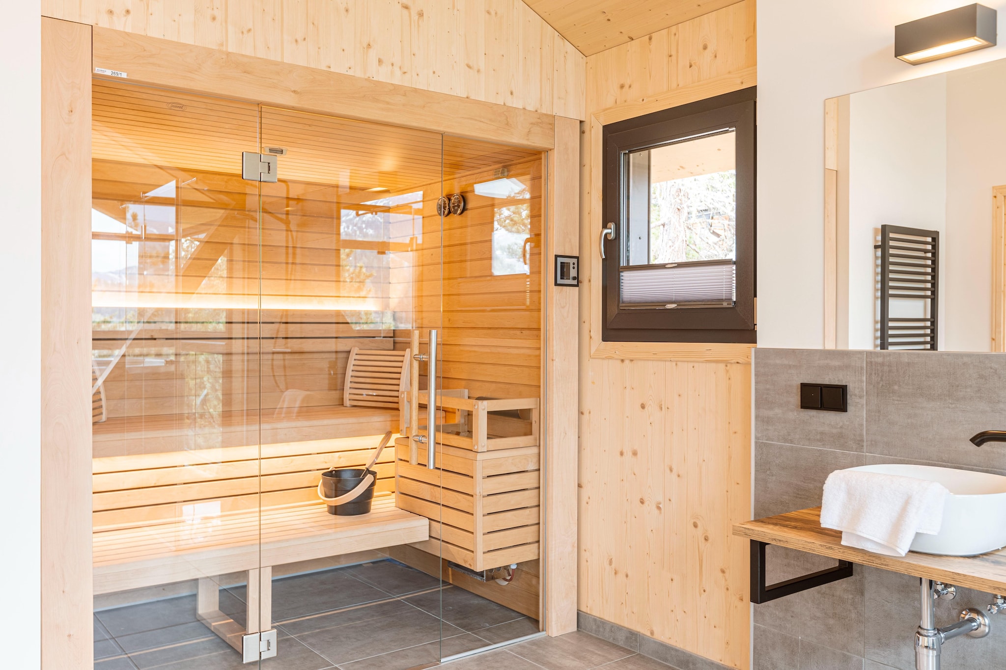 Ground floor: (Bedroom with bathroom(double bed, shower), Bedroom with bathroom(double bed, shower), toilet(toilet), Internet access, balcony)\n\nOn the 1st floor: (Entrance(ski boot heaters), Living room(TV, dining table, seating area), open kitchen(toaster, coffee machine(espresso, filter), oven, microwave, dishwasher, fridge-freezer), toilet(toilet), balcony)\n\nOn the 2nd floor: (bedroom(double bed), bedroom(double bed), bathroom(shower, sauna, balcony, hairdryer), hot tub)\n\nwashing machine, heating(central), garden furniture, parking, parking, drying cabinet