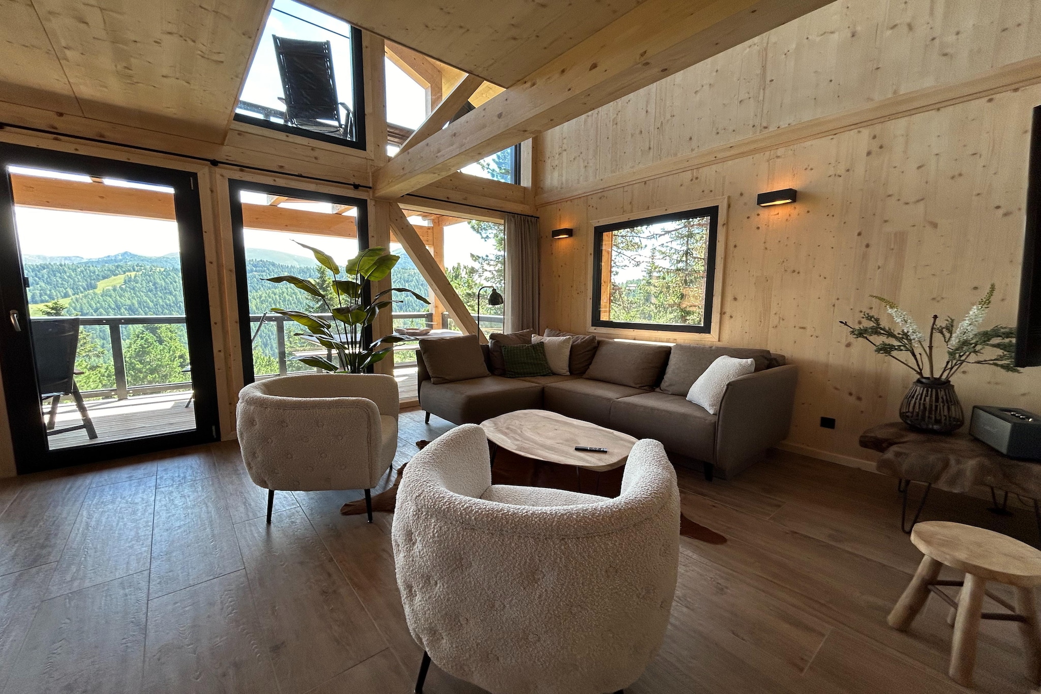 Experience the perfect alpine getaway in this stunning solid wood chalet, offering 135 m² of luxurious space across three beautifully designed floors. Accommodating up to 8 guests, this chalet combines rustic charm with modern comforts, providing an ideal retreat in the heart of the pine forest. After a day of outdoor adventures, unwind in your private sauna or soak in the hot tub, both designed to offer a cozy and relaxing end to your day.  
The chalet features 4 elegantly furnished bedrooms, each with a double bed, and some rooms include private balconies for enjoying the serene forest views. With 4 bathrooms, each with an en-suite shower, plus an additional spacious bathroom with a bathtub, there’s ample convenience and privacy for all guests. 
   
The open kitchen is fully equipped to meet all your culinary needs. It includes a ceramic hob, oven, dishwasher, and a fridge with freezer compartment, along with essential cutlery, cookware, and dishes. Additional appliances such as a toaster, kettle, and coffee machine are also provided. To make your arrival more comfortable, a small starter set including dishwasher tabs, dishwashing liquid (sample), sponge, garbage bags, cleaning supplies, and a tea towel will be ready for you. 
  
Nestled in the tranquil pine forest at approximately 1,800 meters elevation, this chalet offers a serene and picturesque setting. Your stay includes a Butler Card or Butler Programme for personalized service, ensuring an exceptional and memorable experience. Enjoy the blend of luxury, comfort, and natural beauty in this remarkable chalet.