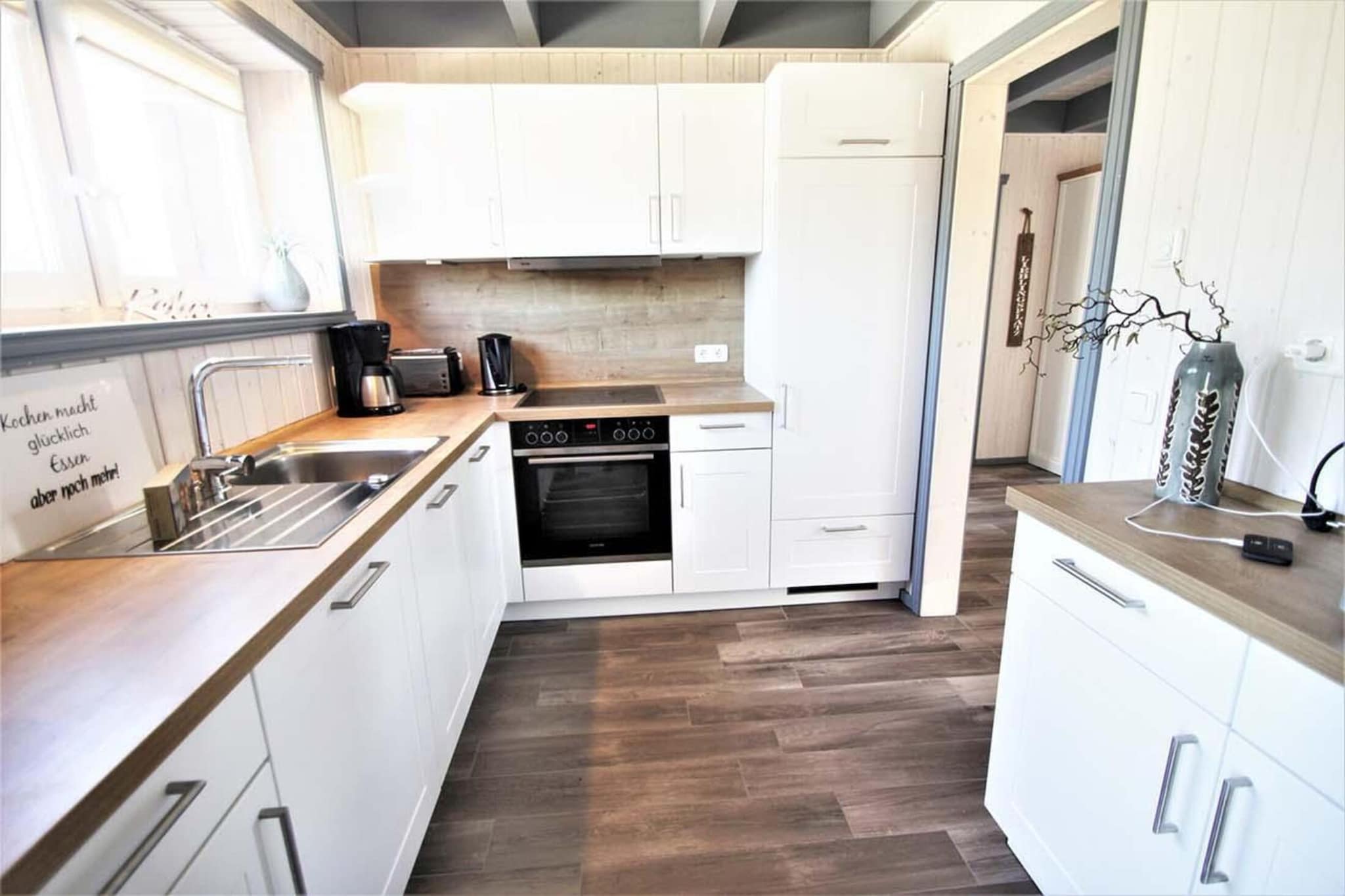 Ground floor: (open kitchen(dining table, hob, electric kettle, toaster, coffee machine, oven, microwave, dishwasher, fridge(+ freezer)), Living/diningroom(TV(satellite), dining table, fireplace, seating area), bedroom(double bed), bathroom(Bubble bath, shower, sauna(private), washbasin, toilet))\n\nAttic: (bedroom(single bed, single bed), toilet(washbasin, toilet), mezzanine(double bed), balcony)\n\ntumble dryer(shared with other guests, paid), washing machine, heating(electric), terrace, garden, garden furniture, BBQ(charcoal), parking, parking, high chair, Charging post for electric cars, baby crib(paid), Towels/Sheets (extra fee)