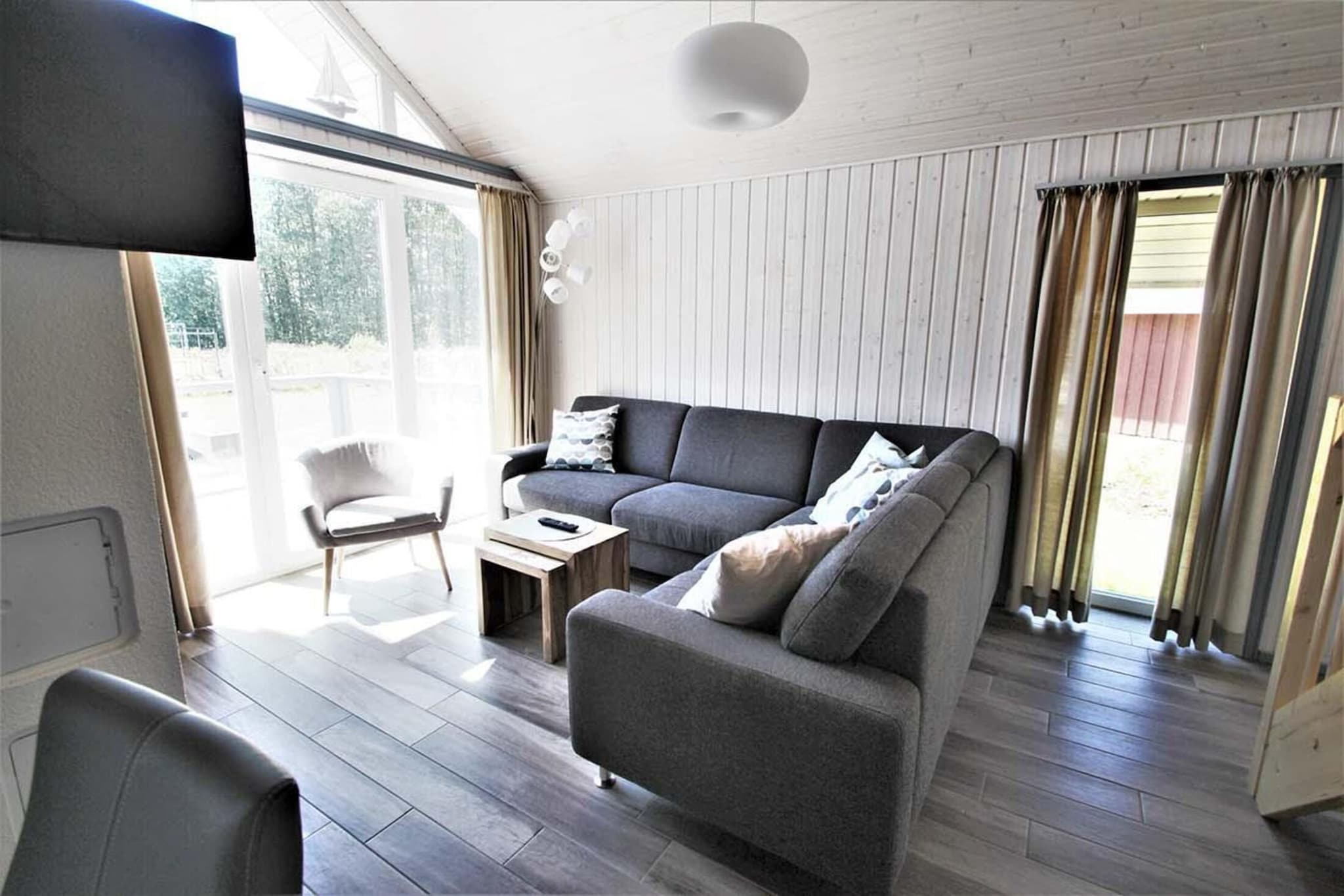 Welcoming Interiors
This two-level holiday home in Granzow is ideal for up to six guests. The ground floor features a double bedroom, a cozy living room with satellite TV and a fireplace, and a fully equipped open kitchen with appliances like a coffee machine, oven, and dishwasher. The bathroom offers a spa-like experience with a bubble bath, shower, and private sauna. Upstairs, guests will find twin beds and a mezzanine with a small double bed, plus an additional toilet and balcony.
Outdoor Living & Essentials
Enjoy the furnished terrace and garden with a charcoal BBQ—perfect for outdoor meals. The home includes electric heating, a washing machine, and access to a paid shared tumble dryer. Families are supported with a high chair and optional baby crib (extra fee), and towels/sheets are available for rent. Two parking spaces make arrival easy and stress-free.
Nearby Fun & Nature
Just 400 meters away, guests can access tennis courts, mini golf, horse riding, and the lake beach. Restaurants, a bakery, bike and boat rentals, and indoor play zones are all within walking distance. Mirow’s town center is only 3.5 km away, offering shops and cultural sights. A peaceful retreat with nature, wellness, and family-friendly adventures awaits in Mecklenburg Western Pomerania.