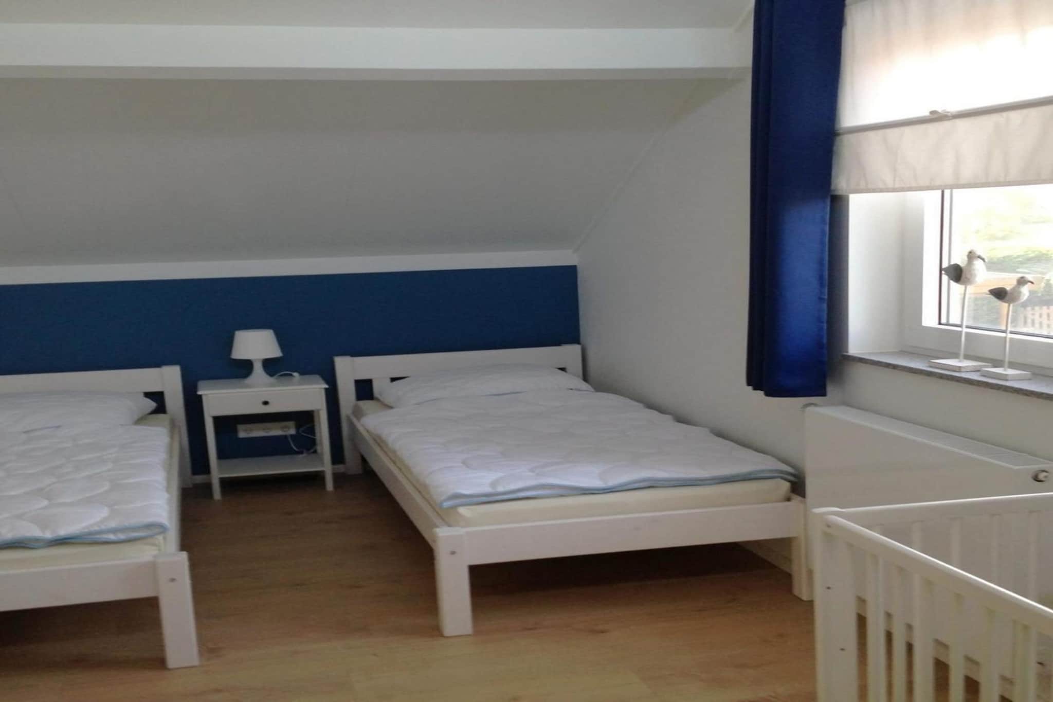 Ground floor: (Living room(TV(flatscreen), dining table, seating area), open kitchen(hob(4 ring stoves, induction), electric kettle, coffee machine(filter), microwave, dishwasher, fridge-freezer, dishes and cutlery(Bowls, chopsticks, plates, cups, etc.), Cooking basics(Pots and pans, oil, salt and pepper)), bedroom(single bed, single bed), Internet access)\n\nOn the 1st floor: (bedroom(single bed, single bed), bedroom(single bed, single bed), bathroom(bath tub, shower, washbasin, toilet), toilet)\n\ncot, washing machine, patio, heating(central), garden, garden(fenced), garden furniture, parking, parking