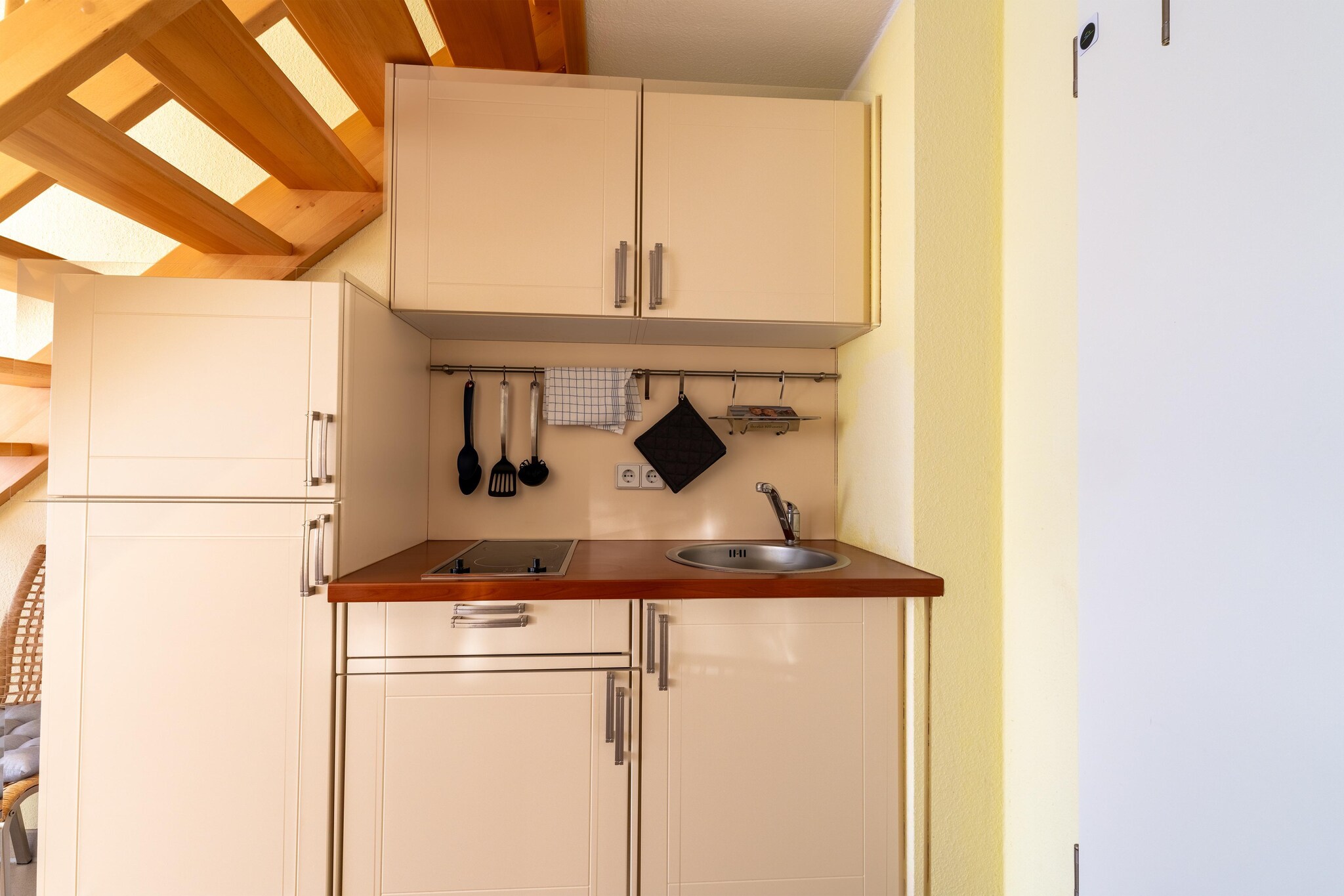 mezzanine: (open kitchen(dining table, hob, electric kettle, toaster, coffee machine, fridge), Living/diningroom(TV, dining table, seating area), bathroom(shower, washbasin, toilet, hairdryer), mezzanine(double bed))\n\ntumble dryer(shared with other guests, paid), washing machine(shared with other guests, paid), balcony, heating(electric), garden furniture, parking, swimming pool(shared with other guests), high chair, baby crib(paid)