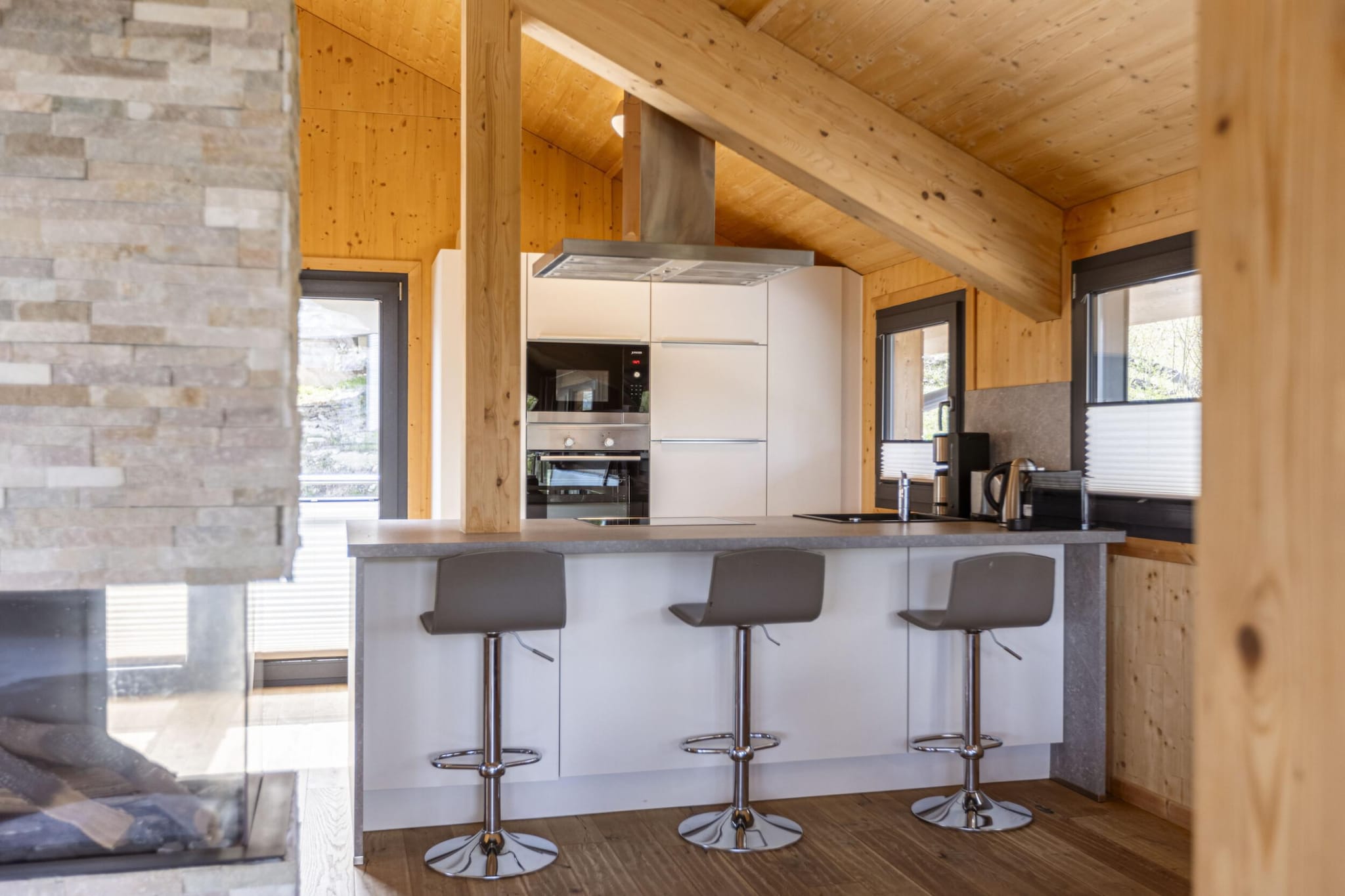 Ground floor: (bedroom(bunk bed, bunk bed), Bedroom with bathroom(double bed, shower), Bedroom with bathroom(double bed, shower), Bedroom with bathroom(double bed, shower), bathroom(bath tub, Bubble bath, sauna, hairdryer), toilet(toilet), toilet(toilet), toilet(toilet), Internet access)\n\nOn the 1st floor: (Living room(TV(cable, satellite), balcony, gas fireplace), open kitchen(hob(4 ring stoves, ceramic), electric kettle, toaster, coffee machine(filter), oven, microwave, dishwasher, fridge(+ freezer), dishes and cutlery(Bowls, chopsticks, plates, cups, etc.)), balcony, terrace)\n\nstorage, washing machine, ski boot heaters, heating(central), garden furniture, parking, drying cabinet