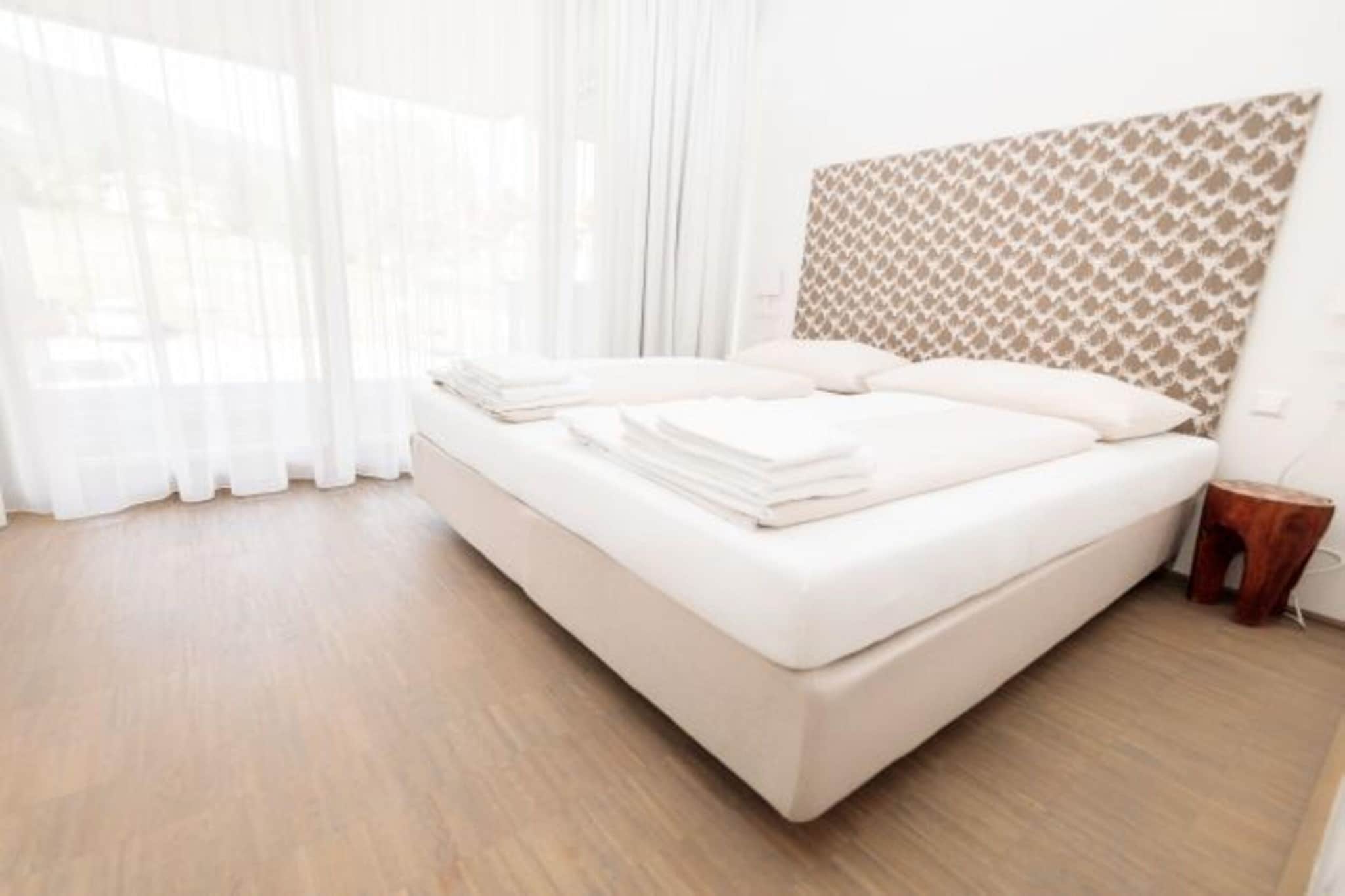 Ground floor: (Living room(double sofa bed, TV(cable, satellite), dining table, seating area), open kitchen(hob(4 ring stoves, ceramic), electric kettle, coffee machine(filter), dishwasher, fridge-freezer, dishes and cutlery(Bowls, chopsticks, plates, cups, etc.)), toilet(toilet), Internet access)\n\nOn the 1st floor: (bedroom(double bed), bedroom(double bed), bathroom(bath tub, toilet, hairdryer), toilet(toilet), balcony or terrace)\n\nBasement: (playroom, sauna)\n\nski storage, carport, tumble dryer, washing machine, ski boot heaters, heating(central), drying cabinet