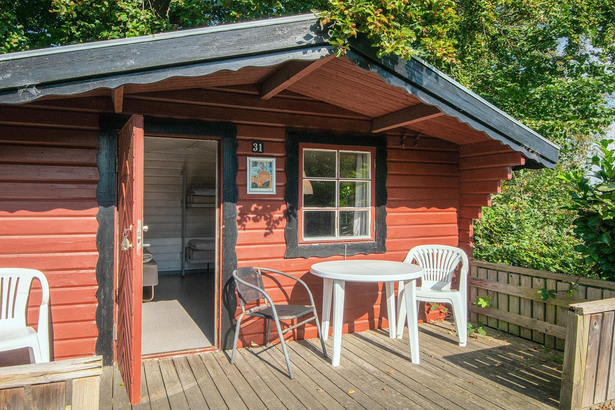 Aabenraa camping is a cozy, well-located site in southern Denmark, just 500 meters from the beach, 300 meters from the forest, and within walking distance of Aabenraa town. Its unique setting offers guests easy access to both nature and local attractions, making it ideal for campers seeking a peaceful stay close to urban conveniences. The site itself is compact and guest-friendly, with short distances between the main building, facilities, and accommodations. Guests can choose from six different types of accommodation, including standard and comfort cabins as well as rooms. Standard cabins vary in size, with some offering kitchenettes and views over the fjord, while the comfort cabins provide modern amenities such as private bathrooms, full kitchens, and spacious terraces. The newest comfort cabins also include underfloor heating and are perfect for small groups or families. Rooms include breakfast, towels, and Wi-Fi, while cabin guests are asked to bring their own linen. Cleaning services can be arranged, and pets are not allowed on-site. Aabenraa Camping also offers a variety of family-friendly activities and facilities on the grounds**: A centrally located playground featuring a bouncy cushion, climbing tower, swings, slide, and playhouse, open daily from 10 am to 10 pm. A multi-purpose ball field and a beach volleyball court for football, volleyball, and other team games. A large outdoor chess board near the main terrace, perfect for friendly matches in a scenic setting. A common room with TV, table football, board games, books, and a cozy space for guests to relax or socialize. These on-site features ensure there's something for all ages, making Aabenraa Camping a welcoming place for families, couples, or solo travelers looking to enjoy both leisure and the outdoors.