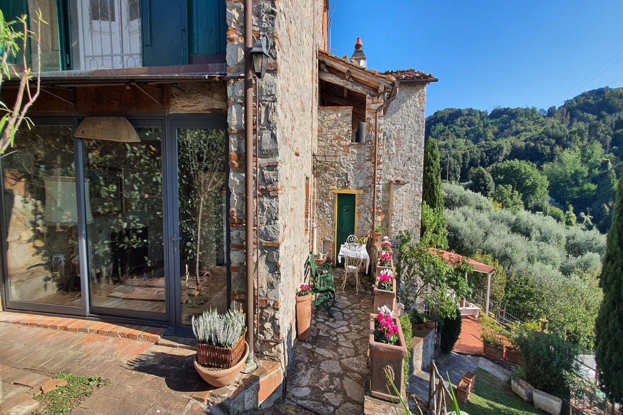 This beautiful semi-detached stone house is located in the tiny medieval hamlet of Chiatri and offers breathtaking views over the coasts of the Versilia and the lake of Massaciuccoli.
The hamlet of Chiatri is known also as the summer residence of the famous composer Giacomo Puccini. The wonderful surrounding nature invites to have relaxing strolls and makes it possible to live fully the contact with the nature of the hills which separate Lucca from the sea.
This house is perfect to visit the lake of Massaciuccoli, the Natural Park of Migliarino – San Rossore and to go to the beach to Torre del Lago Puccini or the famous beaches of Versilia.
Music lovers can attend the famous Puccini festival which takes place every year in July and August.
The Natural Park of the Alpi Apuane and art cities like Pietrasanta, Lucca, Pisa and Florence can be easily reached by car and can be visited in a day trip.
Several cycle paths, which are suitable for racing bikes and/or mountain bikes, start from Chiatri and lead to Lucca on one side or to the seaside on the other. They are the ideal option for those who want to alternate a visit to the mountains to one to the sea. There are also panoramic 5 km walking paths, which are suitable for everyone.
This house has been renovated with great care and consists of a beautiful panoramic terrace (c.ca 4 sqm) with a small table and chairs and of a c.ca 100 sqm garden with gazebo, rattan sofas and armchairs, table, chairs and barbecue, private wooden above ground octagonal swimming pool (5.60 m x 3.70 m, 1.20 m depth) with deck chairs.
The garden offers breathtaking views on the lake of Massaciuccoli and the coasts of the Versilia.
The house consists of: on the ground floor, entrance in the kitchen with stovetop, small electric oven, microwave, fridge/freezer, toaster, filter coffee brewer, dining table, living room with sofa, SAT Tv.
On the first floor: walk-through room with 1 single sofa-bed, 1 twin bedroom, 1 double bedroom, 1 bathroom with shower, toilet, bidet and basin.
The house is furnished with great care in country style with antique furnishings and great attention to upholstery and furnishing details, wooden beamed ceilings, terracotta floorings, pastel-coloured walls and some walls in exposed stone.
Parking available near the house. Washing machine in the boiler room next to the house entrance, fans at disposal, mosquito nets, safe and Wi-Fi connection.