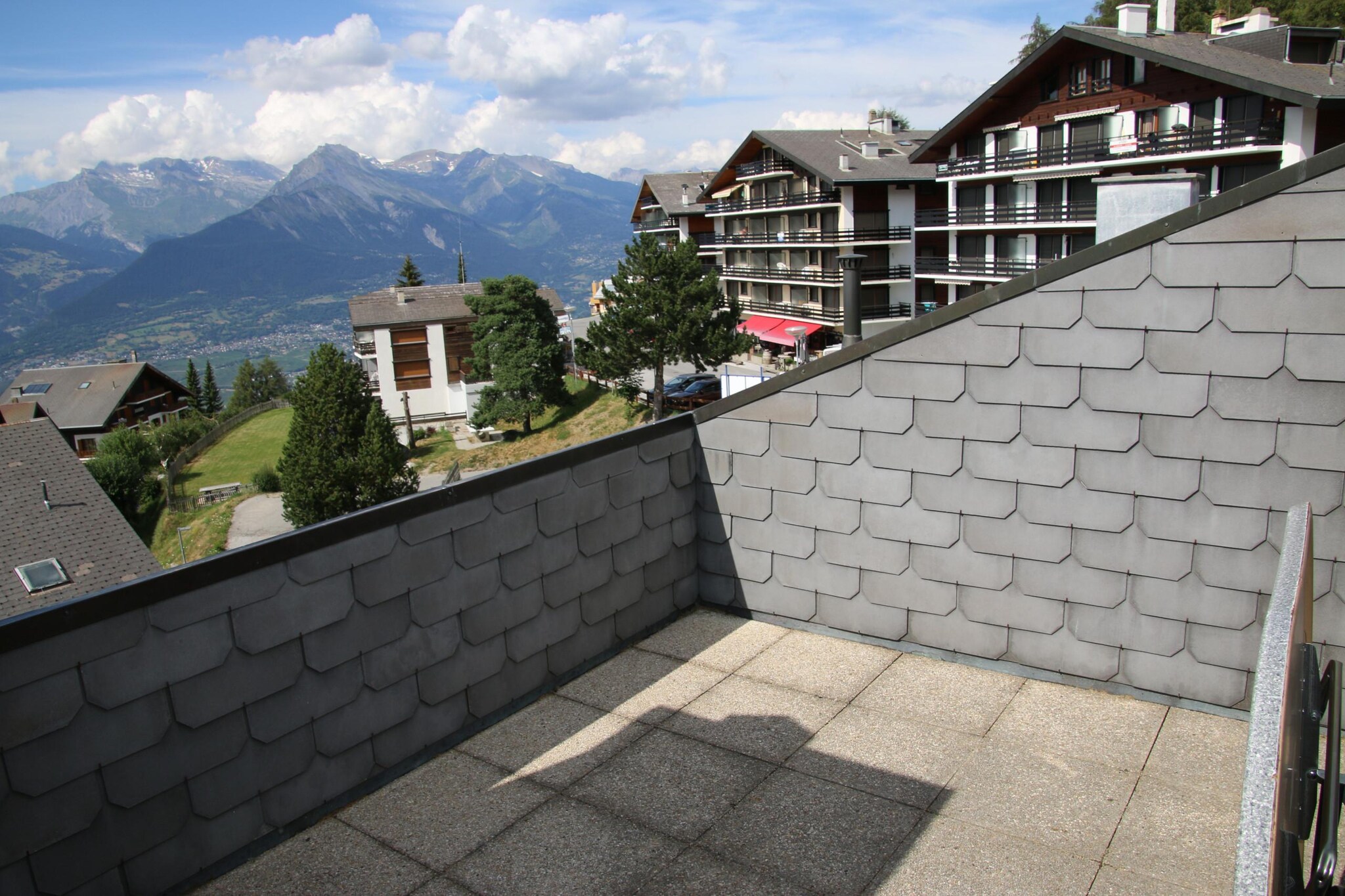 This cozy apartment comfortably accommodates up to 7 guests, featuring three bedrooms, including a double bed, two single beds, and a bunk bed combination, ensuring ample sleeping arrangements. A welcoming living area includes a sofa and a fireplace, perfect for relaxation. The property also boasts a balcony with breathtaking views of the Rhône Valley. Pet-friendly policies allow small pets (up to 15 kg), and additional services such as bed linen and final cleaning can be arranged. Guests also benefit from access to a public swimming pool and discounts on equipment rentals during their stay.
Nestled in the heart of Veysonnaz, the apartment is ideally situated just 500 meters from the cable car, facilitating easy access to skiing and hiking adventures. Local shops are a mere 140 meters away, providing convenience for groceries and essentials. The vibrant resort offers a variety of leisure activities nearby, making it an excellent location for both winter and summer vacations. Accessible transportation options, including buses and train stations, are within a reasonable distance, connecting guests to the broader region.
The fully equipped kitchen features essential appliances, including an oven, dishwasher, and coffee maker, allowing for convenient meal preparation. The accommodation includes two bathrooms—one with a bathtub and the other with a shower—ensuring comfort and privacy for all guests. Additionally, the apartment offers shared amenities such as a ski room and laundry facilities in the building.