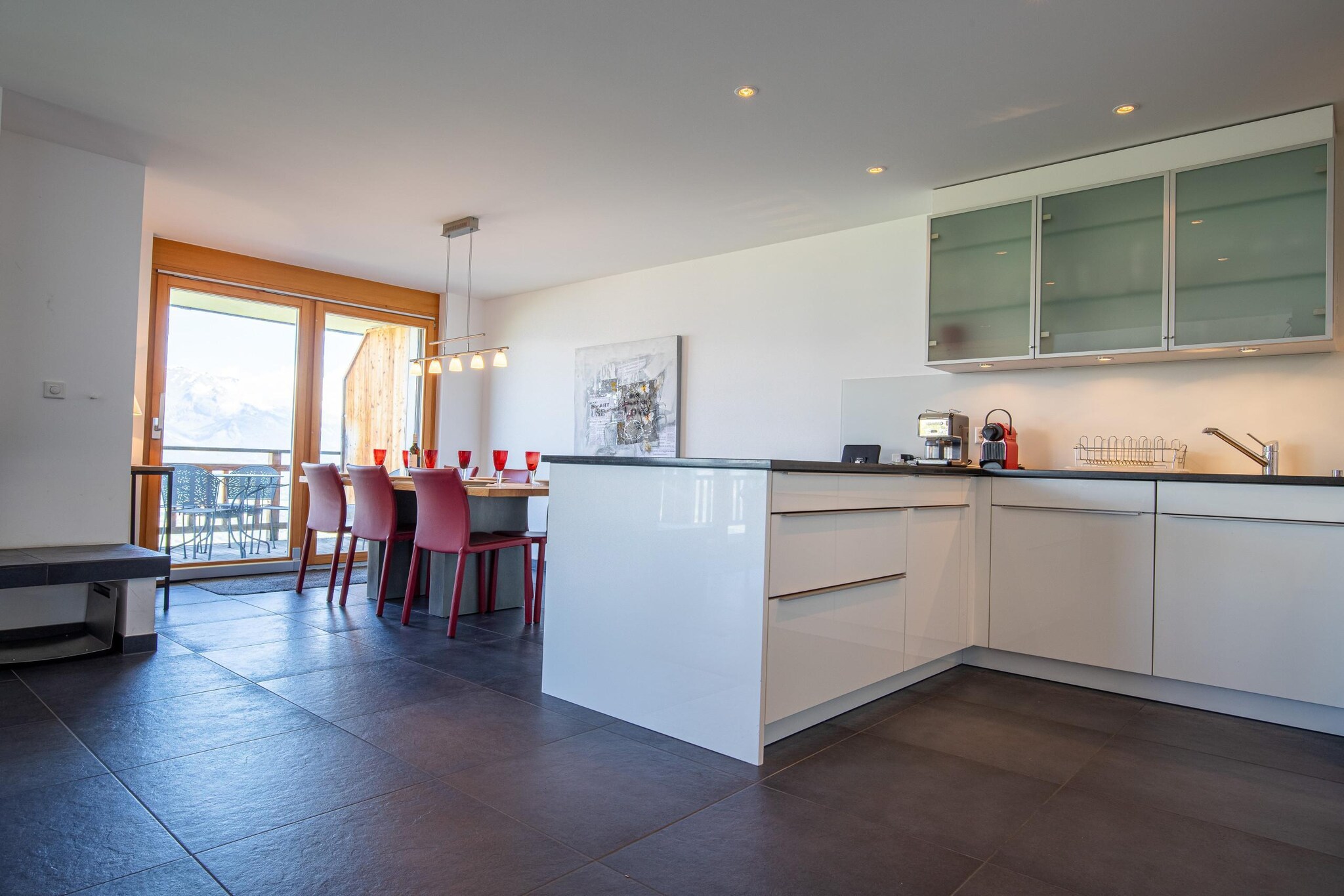 On the 4th floor: (Living room(TV(flatscreen, satellite), fireplace, fireplace, DVD player, radio), open kitchen(electric kettle, toaster, coffee machine(filter), oven, microwave, dishwasher, fridge, freezer, dishes and cutlery), bedroom(single bed, single bed), bedroom(single bed, single bed), bedroom(single bed, single bed), bathroom(bath tub, toilet), bathroom(shower, toilet, hairdryer))\n\nski storage, hot tub, sauna, washing machine, balcony, heating(central), lift, iron