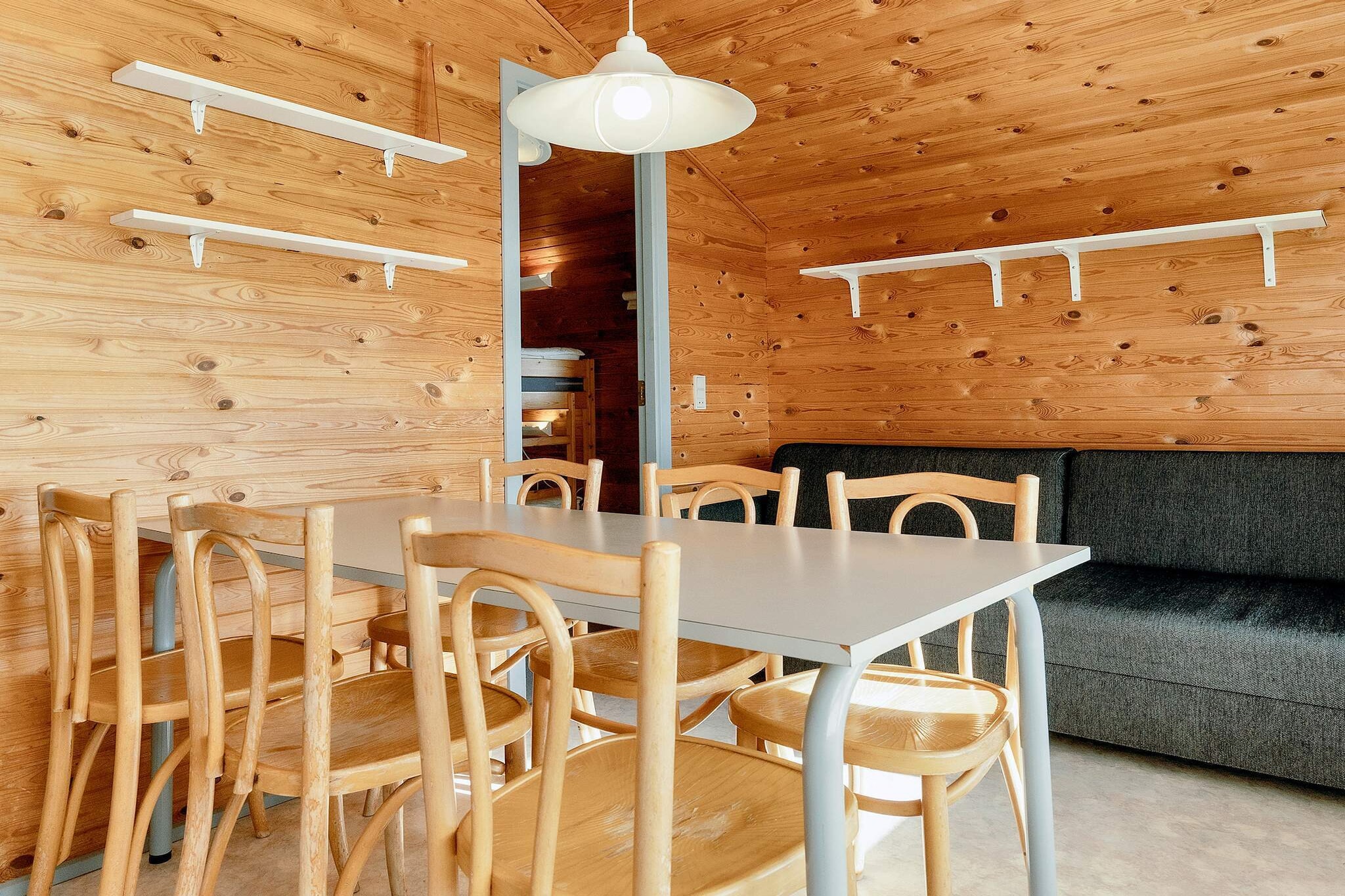 This small holiday cabin offers, among other things, a private toilet, a small wooden terrace and a maximum of 5 sleeping places. The cabins have a large window section at the western end of the cabin, which makes them very light and inviting. The terrace, which overlooks the playground, bouncy cushion and ball field, is fully covered. The cabins have 2 bedrooms, each with a bunk bed (with new mattresses from 2023) and a wardrobe. There is also a sofa bed in the living room. There are tables and chairs, both inside and outside. In each cabin there are 5 duvets and 5 pillows and there is also crockery and cutlery as well as a coffee maker, kettle, hob, refrigerator and sink with cold water. The cabin is heated with an electric radiator. Dogs are welcome in the cabin, but not in the furniture or beds. There are cleaning products and equipment in the cabin. You can either bring your own bed linen/towels or rent them for DKK 100 per person. The linen packages consist of: sheets, bed linen (for pillows/duvets) and towel (must be ordered in advance).

A refundable deposit might be charged closer to your check-in date. This deposit covers utilities consumed during your stay and any additional services that may be taken. The final amount will be adjusted based on actual meter readings, actual usage of extra services, and any remaining balance will be refunded within 21 days after checkout.