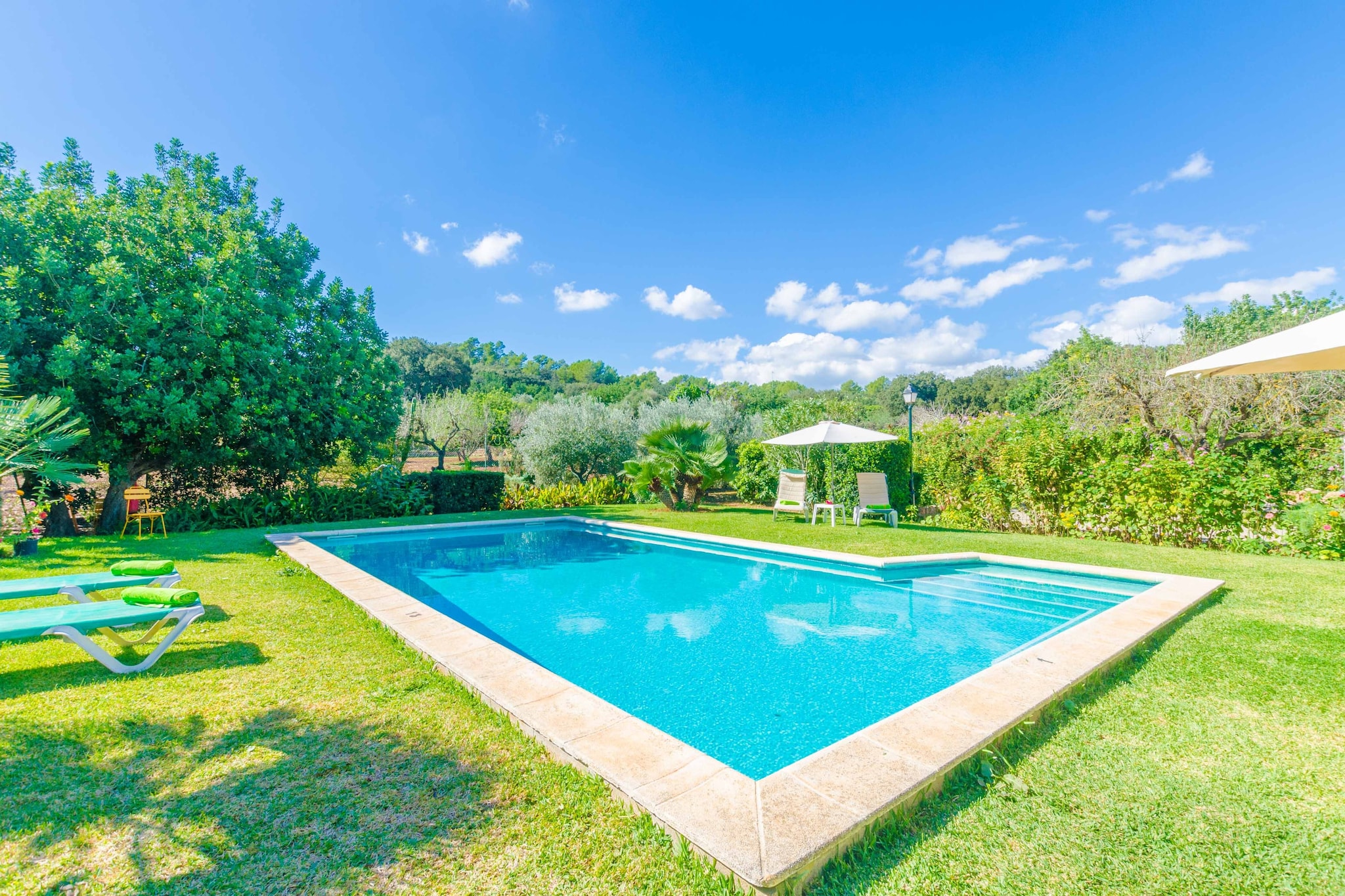 The exterior area of this property is very beautiful. It's surrounded by the landscape of the fields and the mountains. You can cook a delicious BBQ outdoors and enjoy it at the hurdle roofed terrace, cool down in the private chlorine pool -that sizes 10 x 5 metres and is 2 metres deep- or simply relax at the garden or on one of the sunbeds. The property is full of greenery around and you'll also find fruit trees like almond or orange trees. It offers total privacy.
The two-storey house offers a charming traditional but modern atmosphere. You can rest or enjoy a reading in the air-conditioned living room which is equipped with satellite TV. Behind a great arch you'll find the dining area with a great table for 8 people and with access to the kitchen, equipped with a ceramic hob. There's a washing machine, an iron and an ironing board. The house features 3 bedrooms, all with closet and AC, and all of them located on the 1st floor. One has a double bed and the other 2 have twin beds. A cot and a high chair are available. Finally, there is a bathroom with a bath on the main floor and another with a shower upstairs.
The house is only 3.7 km away from sa Pobla where you'll find all you need for an independent stay like supermarket, bars, restaurants, etc. The paradisaical beaches of Puerto de Alcudia, ses Casetes des Capellans or Can Picafort are only a 20 minutes drive away. Consult the advertiser for possible charges. Pets are not allowed. The holding of events is forbidden. There is exterior parking for 3 cars.
Distances
Beach: 13.7 km - ALCÚDIA
Airport: 42.4 km - PALMA
Golf course: 12.2 km - POLLENÇA
Town: 3.7 km - SA POBLA
Train station: 3.7 km - SA POBLA
Bus stop: 3.7 km - SA POBLA
Ferry: 17.6 km - PORT ALCÚDIA
Hospital: 10.3 km - INCA
Tourist license: ETV/3022Single Rental Registry: ESFCTU00000702200008182000000000000000000000ETV/30221There's a mandatory tourist tax in Balearic Islands, called Ecotasa. All guests, except people under 16 years, have to pay this tax. The amount varies between 0.55€/night and guest during the low season and 2.2€/night and guest during the high season .The tax is reduced by half from the 9th day for your stay. Homerti - Central de Reservas CR/33 Electricity (January - December): 0.30 EUR/KW (mandatory) <br> <br />